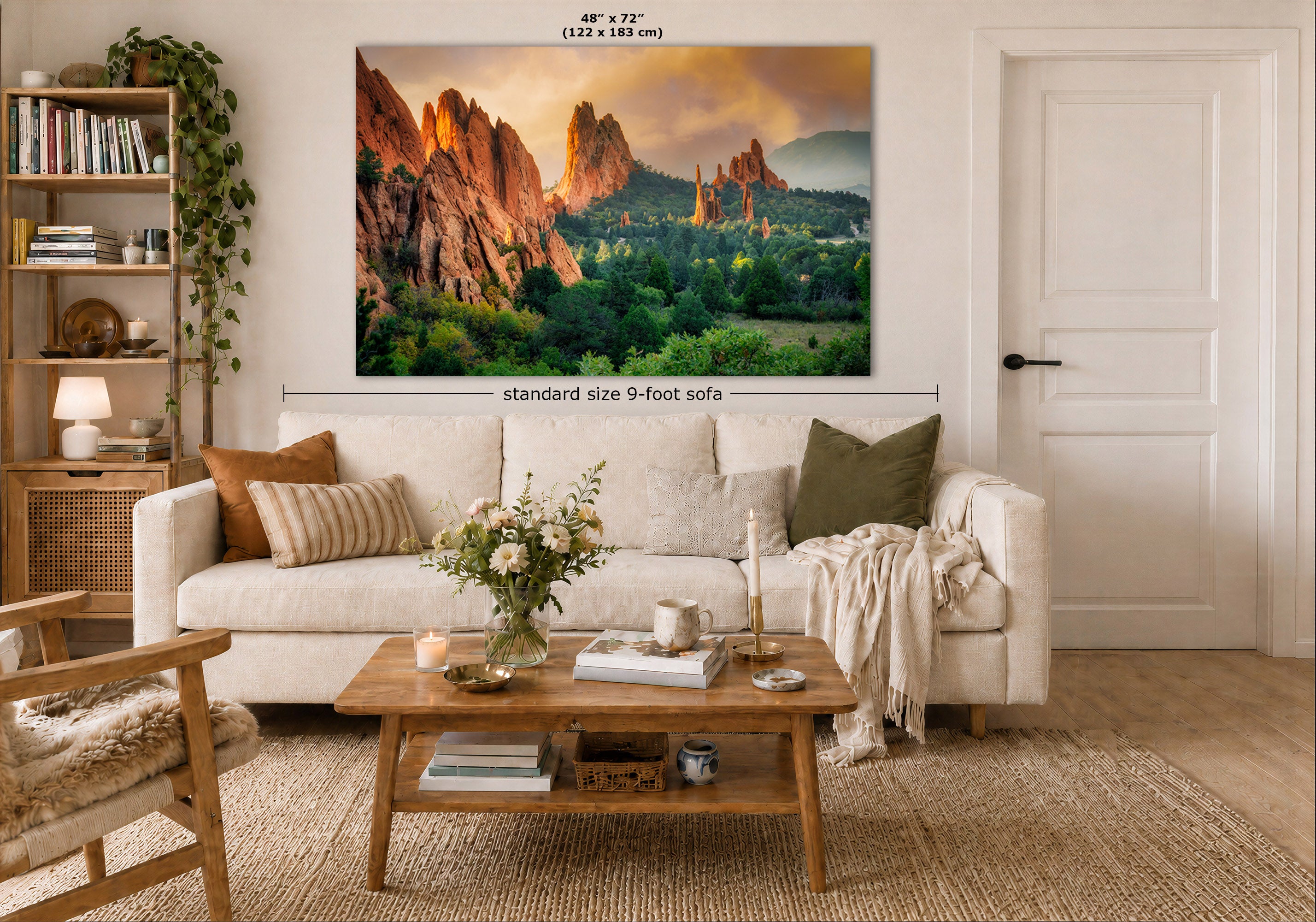 A large wall art print showing a colorful desert canyon landscape is displayed above a white sofa in a styled living room. The print includes size markings indicating 48 x 72 inches (122 x 183 cm), and the room scene is shown from a high angle.