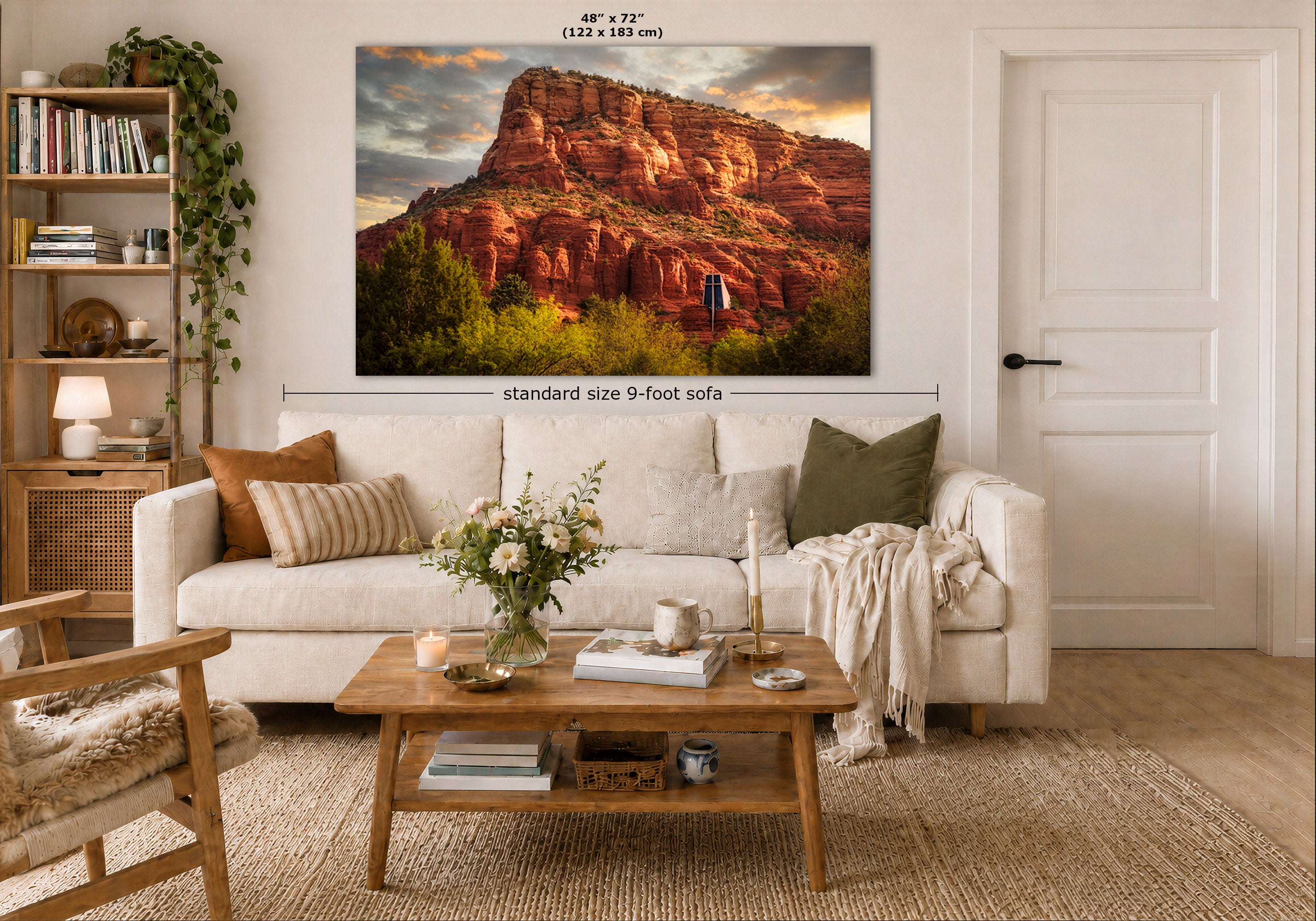 A large wall art print showing a desert rock landscape is displayed above a white sofa in a styled living room. The print includes dimension labels reading 48 x 72 inches and a note about standard size 9-foot sofa.