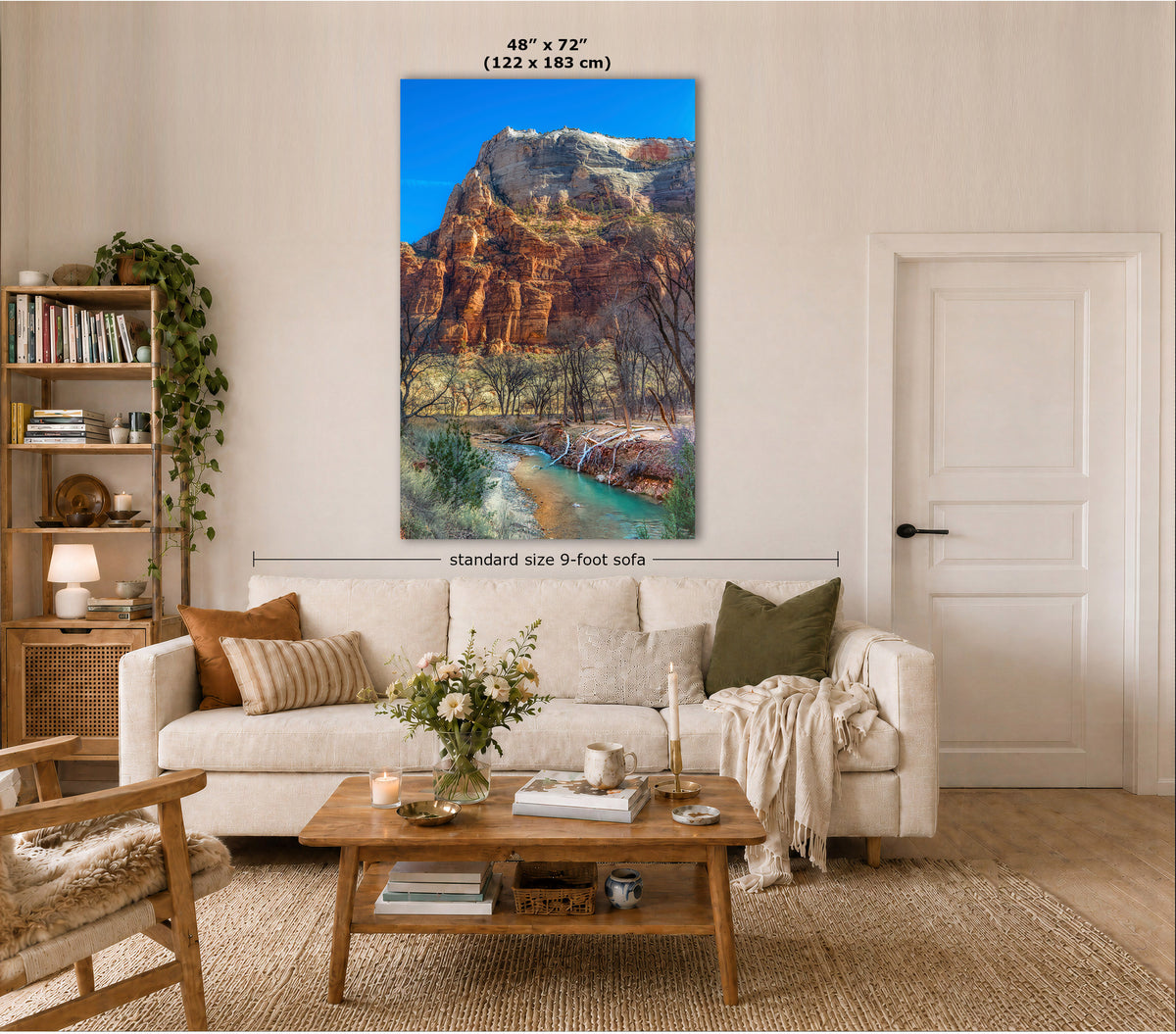 A large vertical canvas print of a red rock canyon landscape with a river, displayed on a wall in a styled living room above a sofa. Text overlays indicate the dimensions of the canvas and a 9-foot sofa.