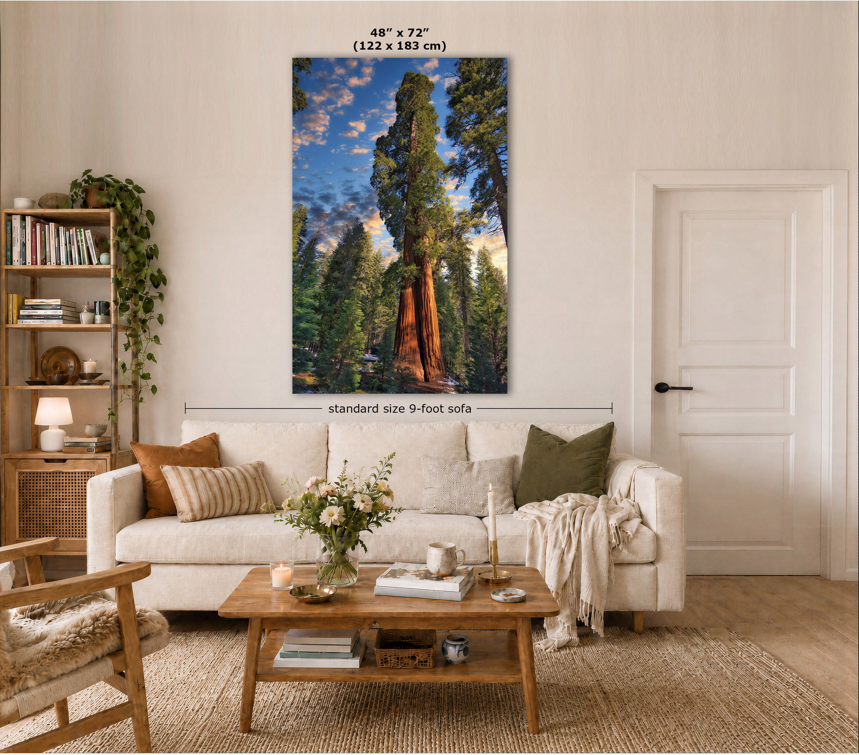 A large vertical wall art print showing a giant sequoia forest scene, displayed above a white sofa in a styled living room. The print includes size text indicating 48" x 72" (122 x 183 cm) and a dimension line labeled standard size 9-foot sofa.