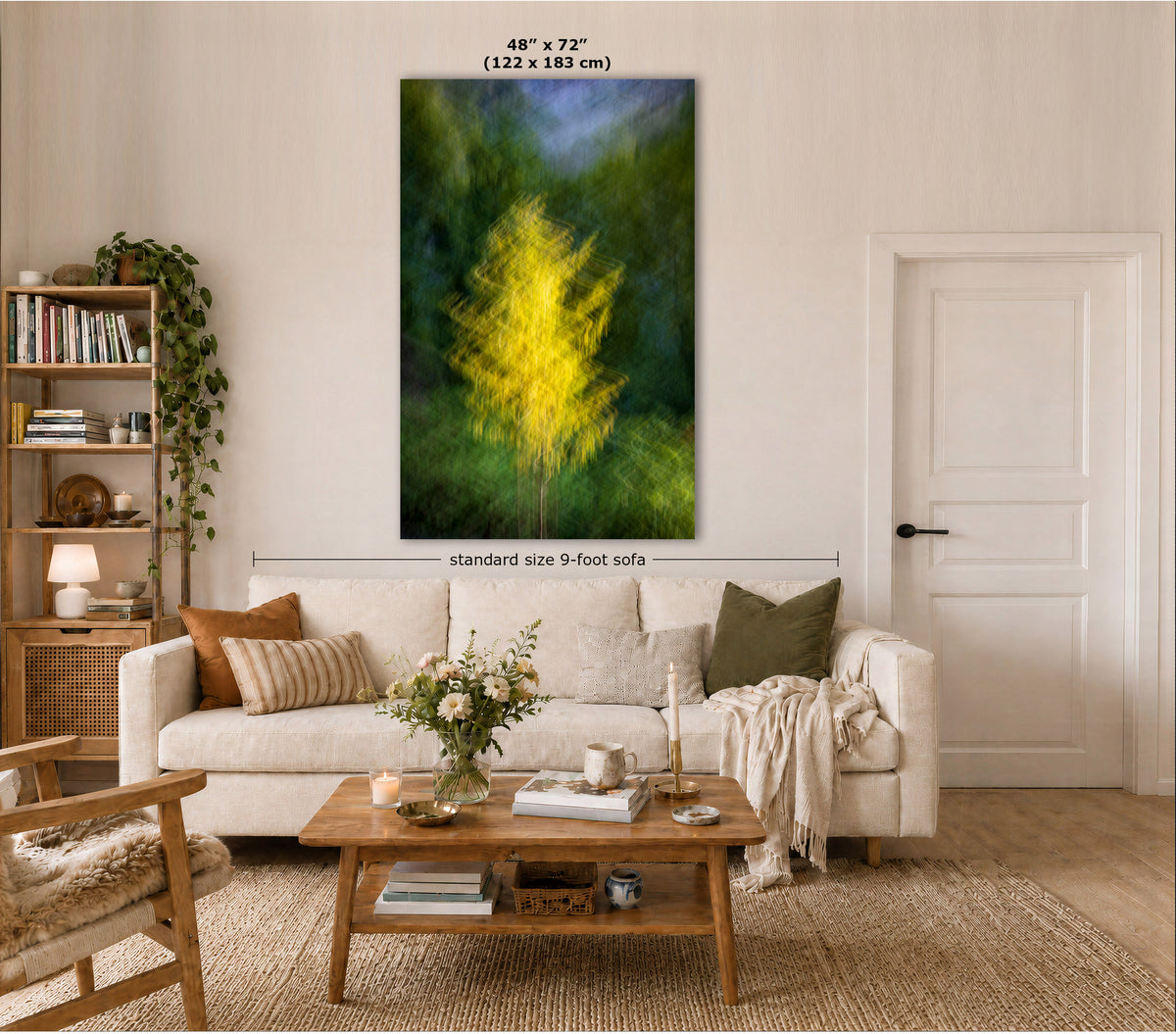 A large vertical canvas wall art print showing a glowing yellow tree against a dark green and blue background, displayed above a white sofa in a styled living room. Text overlays indicate the dimensions as 48" x 72" (122 x 183 cm) and a standard size 9-foot sofa width.