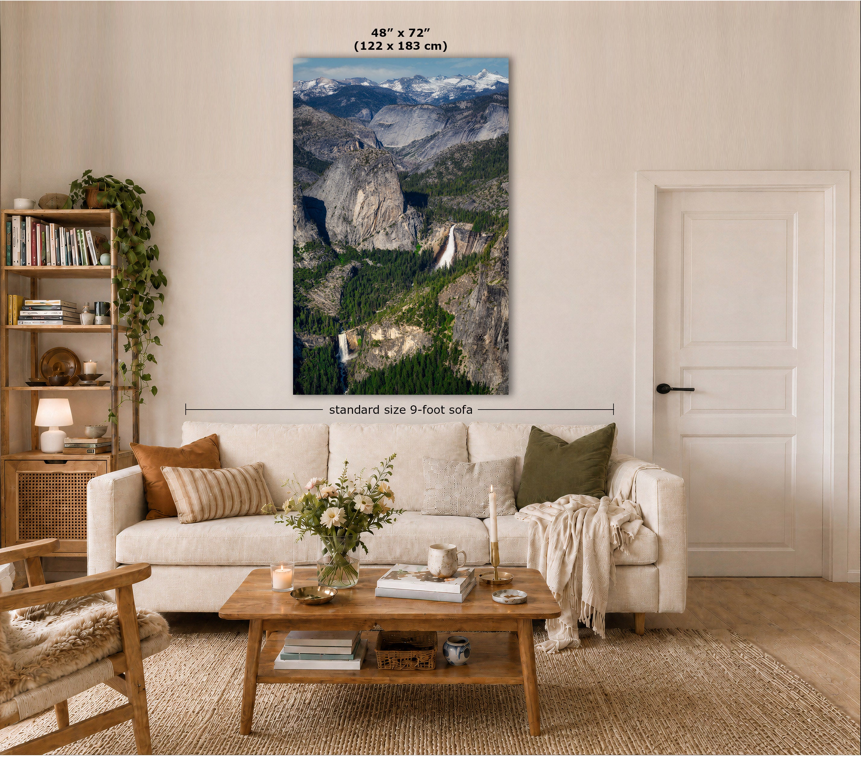 A vertical wall art print showing a mountain landscape with waterfalls, displayed above a white sofa in a styled living room. Text on the image indicates the print size as 48" x 72" (122 x 183 cm) and notes standard size 9-foot sofa.