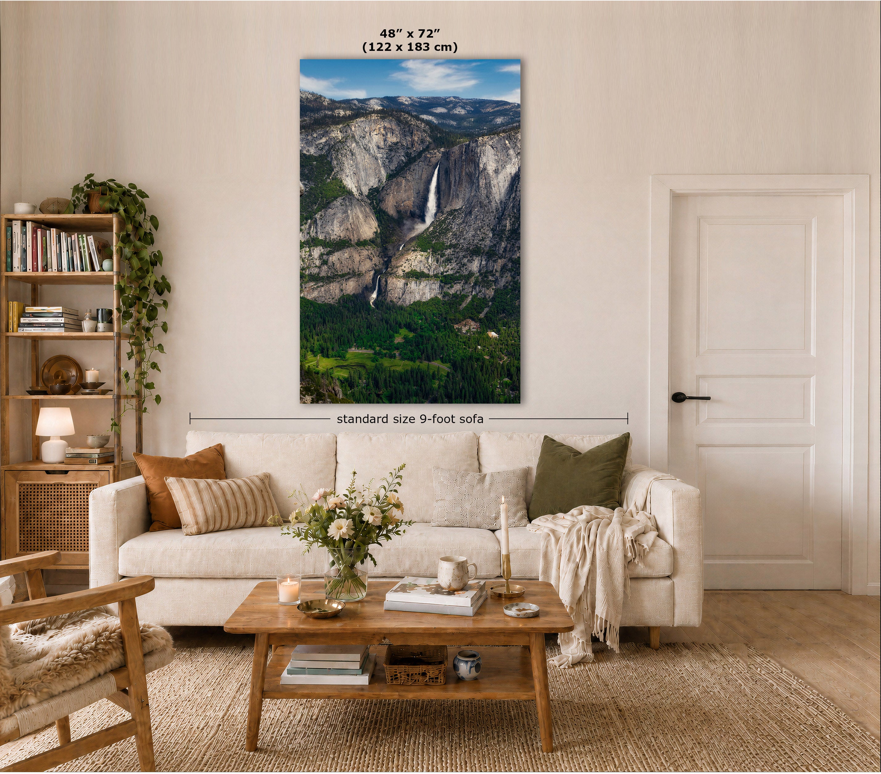 A large vertical wall art print showing a mountain landscape with a waterfall, displayed above a white sofa in a styled living room. Text on the image indicates the print size as 48" x 72" (122 x 183 cm) and notes standard size 9-foot sofa context.