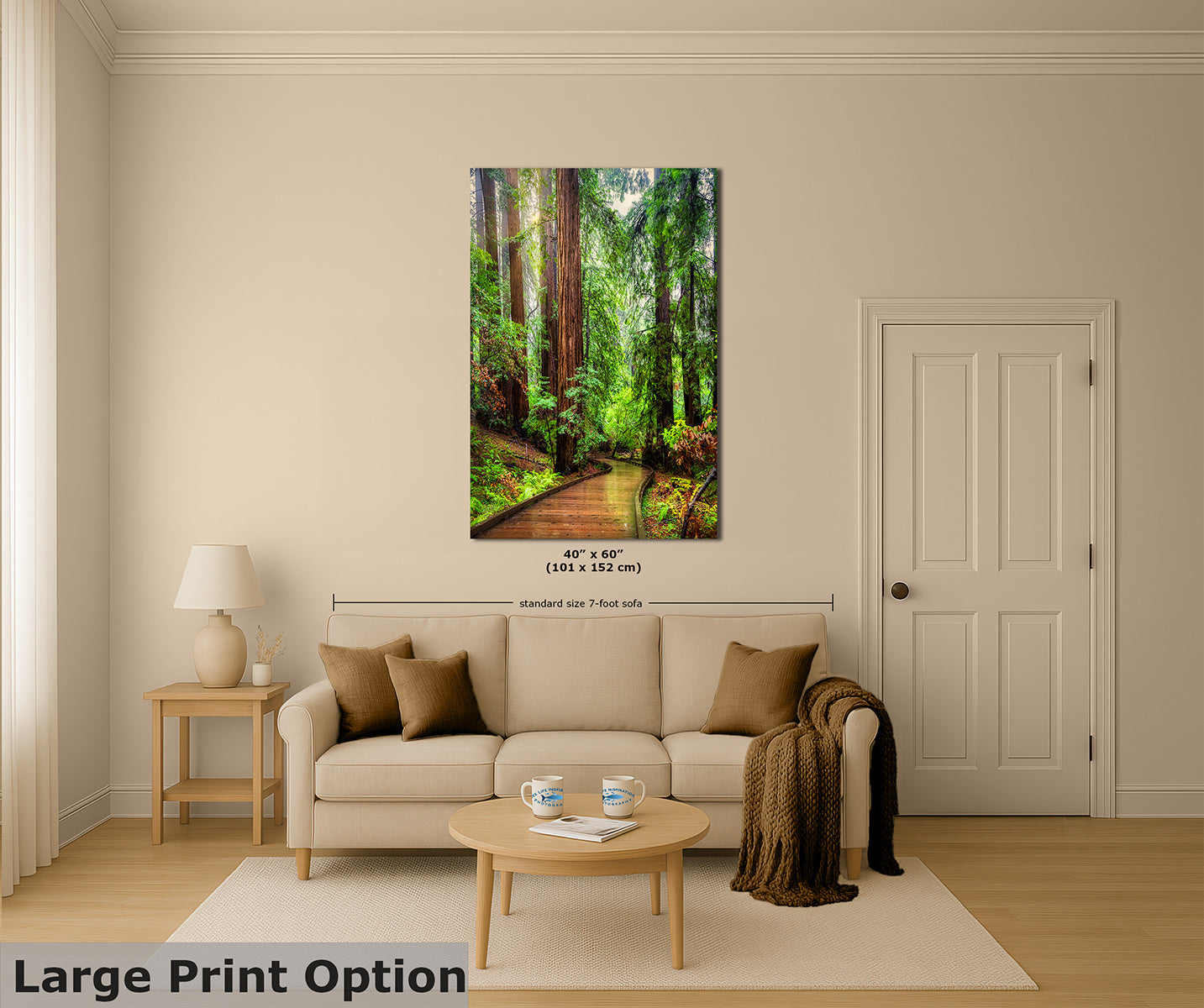 A vertical canvas wall art print depicting a lush green fRedwood orest path with giant trees, displayed on a beige wall above a modern beige sofa in a styled living room mockup. The image includes dimension lines and text indicating '40" x 60" (101 x 152 cm)' and 'Large Print Option'.