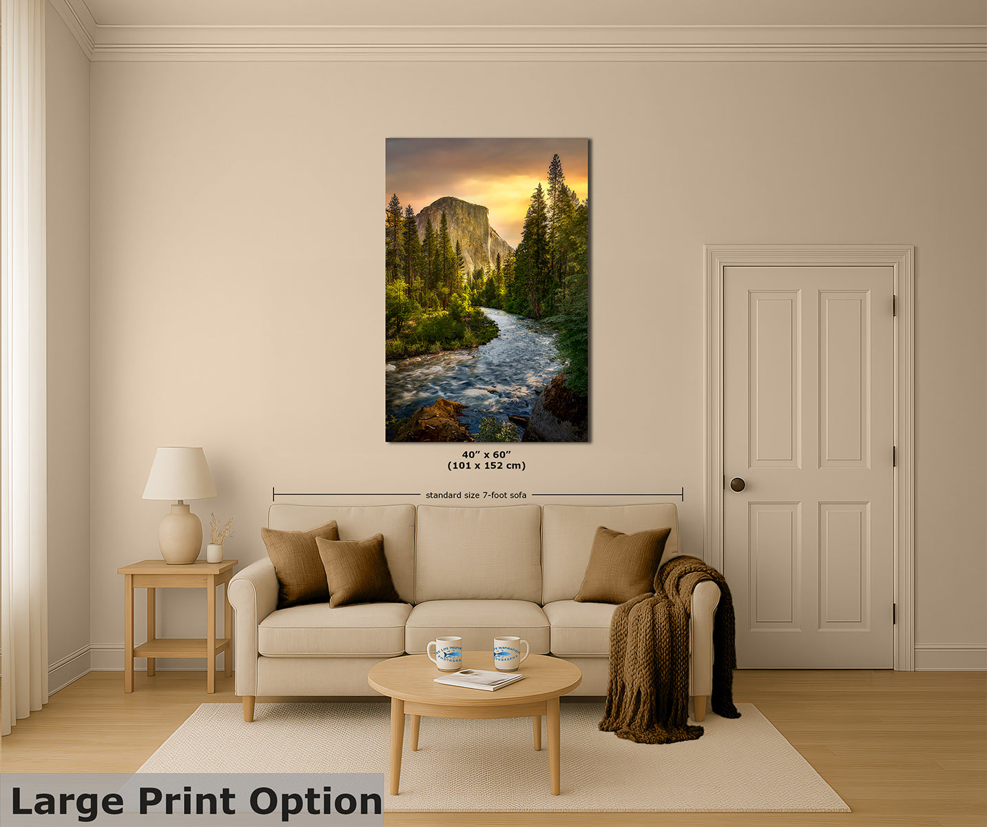 A large vertical wall art print of a Yosemite mountain river landscape with a sunset is displayed on a beige wall above a cream sofa in a styled living room. The image includes dimension markings and a text overlay reading 'Large Print Option'.