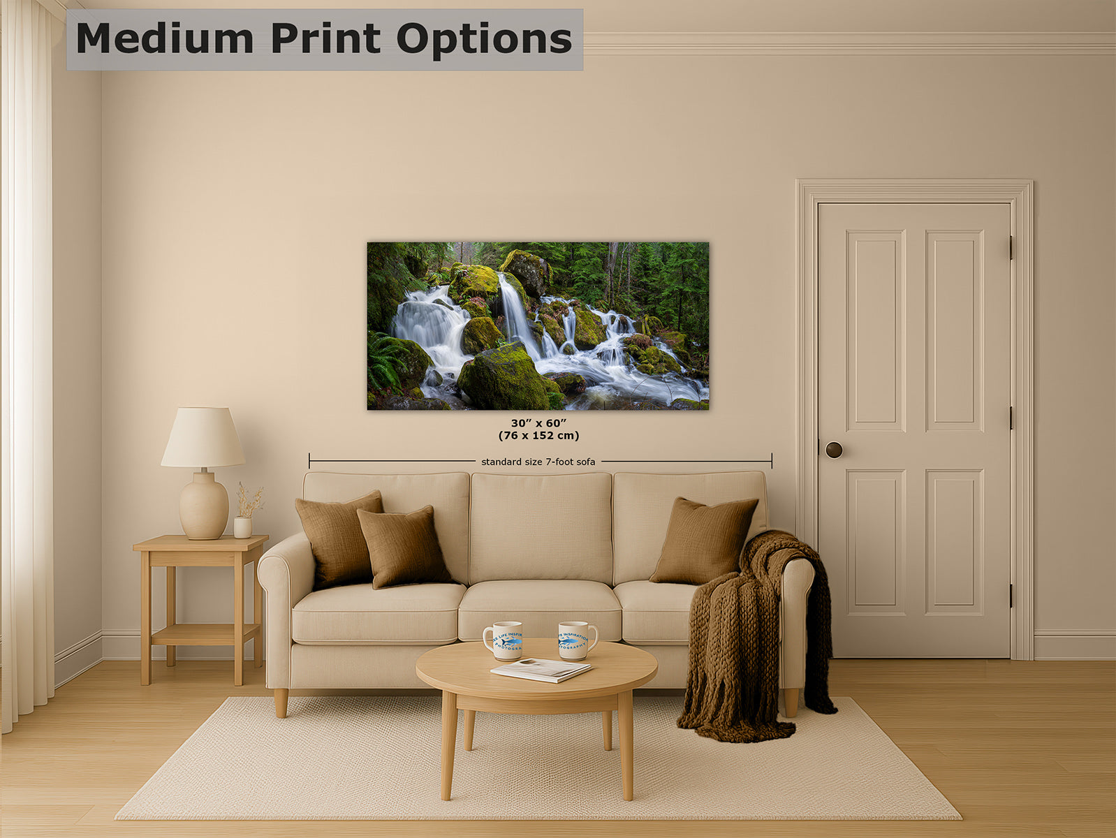 A framed wall art print showing a forest waterfall scene, displayed above a beige sofa in a styled living room. The image includes text reading 'Medium Print Options' and size information overlaid on the print.