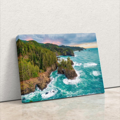 an aerial view of the ocean with a cliff in the foreground