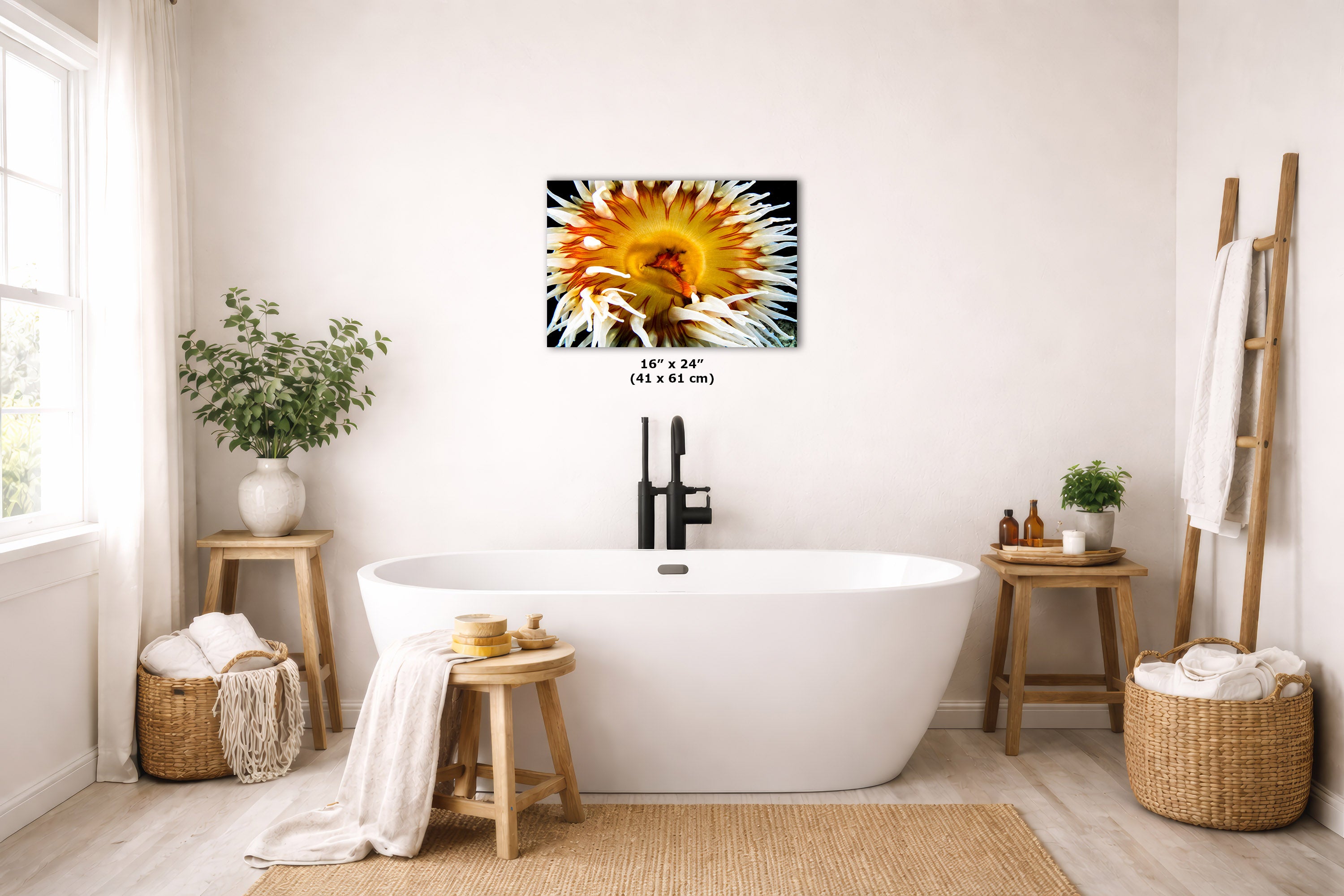 A wall art print of a close-up yellow anemone, displayed above a white freestanding bathtub in a bright, modern bathroom setting.
