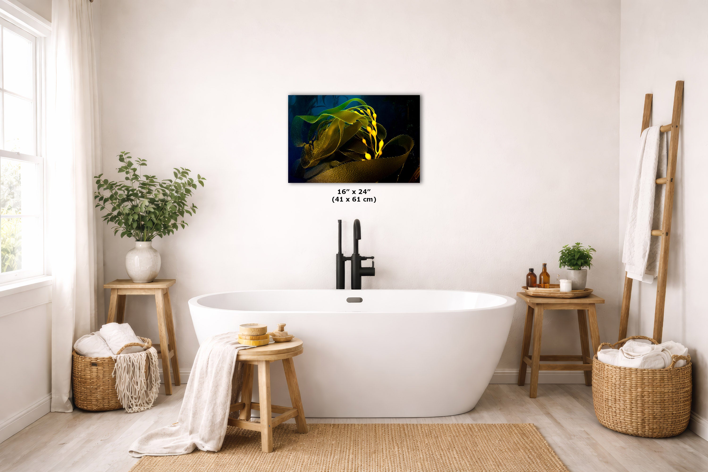 A wall art print showing a glowing green and yellow abstract underwater scene, displayed above a white freestanding bathtub in a bright, modern bathroom with wooden stools, baskets, and plants.