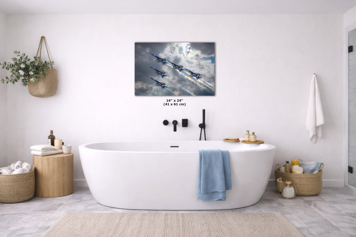 A wall art print showing five blue jets flying through white clouds, displayed above a white freestanding bathtub in a bright, modern bathroom. The print includes size text reading 16 x 24 in (41 x 61 cm).