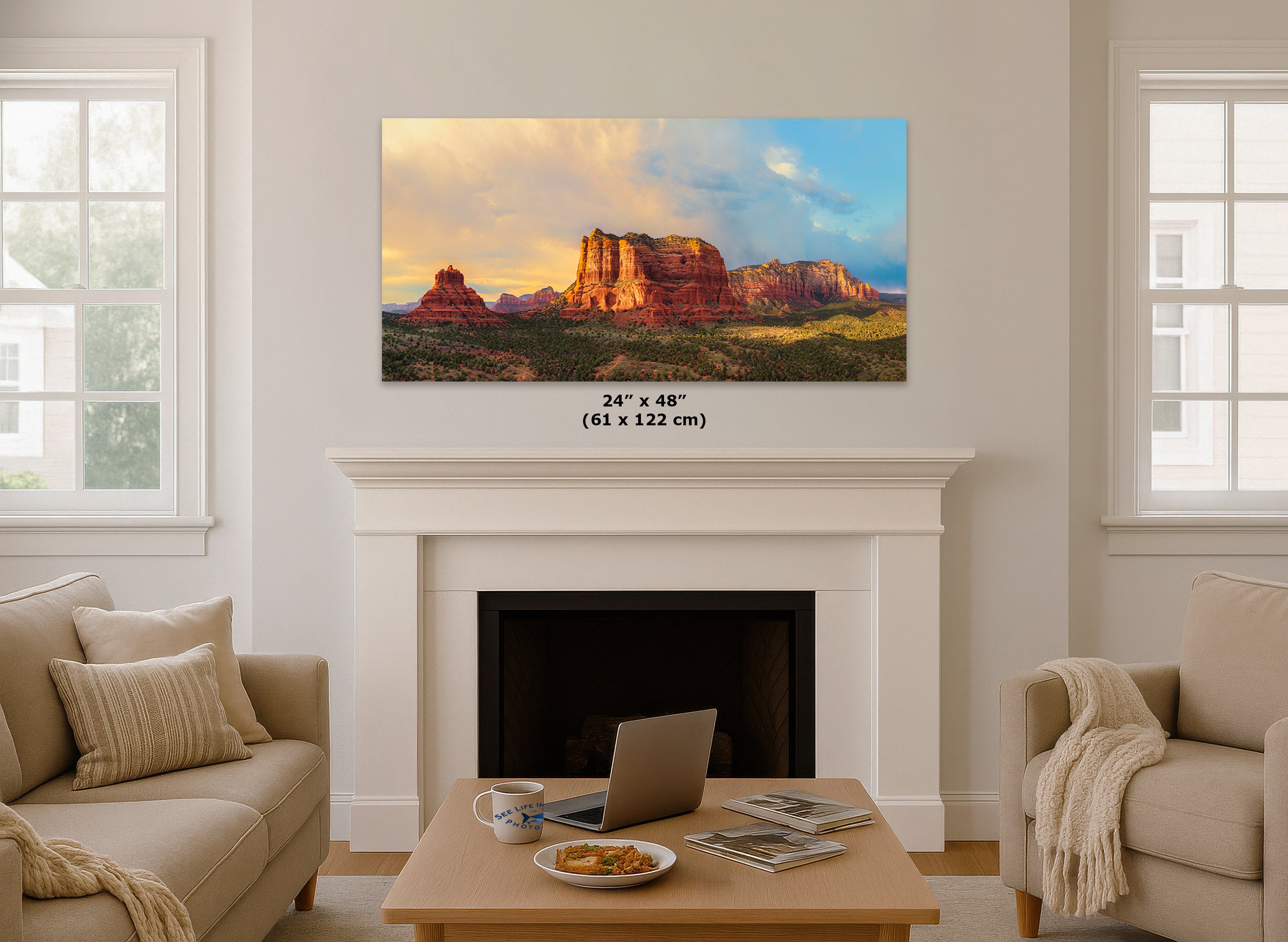 A 24 x 48 inch canvas print of Sedona, Arizona, displayed on a white fireplace mantel in a bright, modern living room. The canvas features a colorful sunset landscape with red rock mesas under a blue sky.