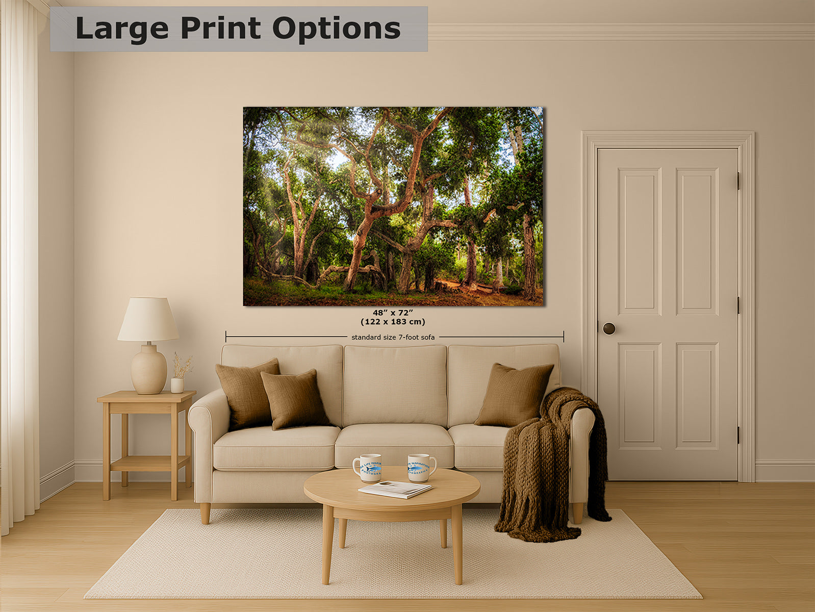 A large wall art print showing a sunlit coast live oak forest scene with trees and dappled light, displayed above a beige sofa in a styled living room. The image includes the text 'Large Print Options' and size markings for the print.