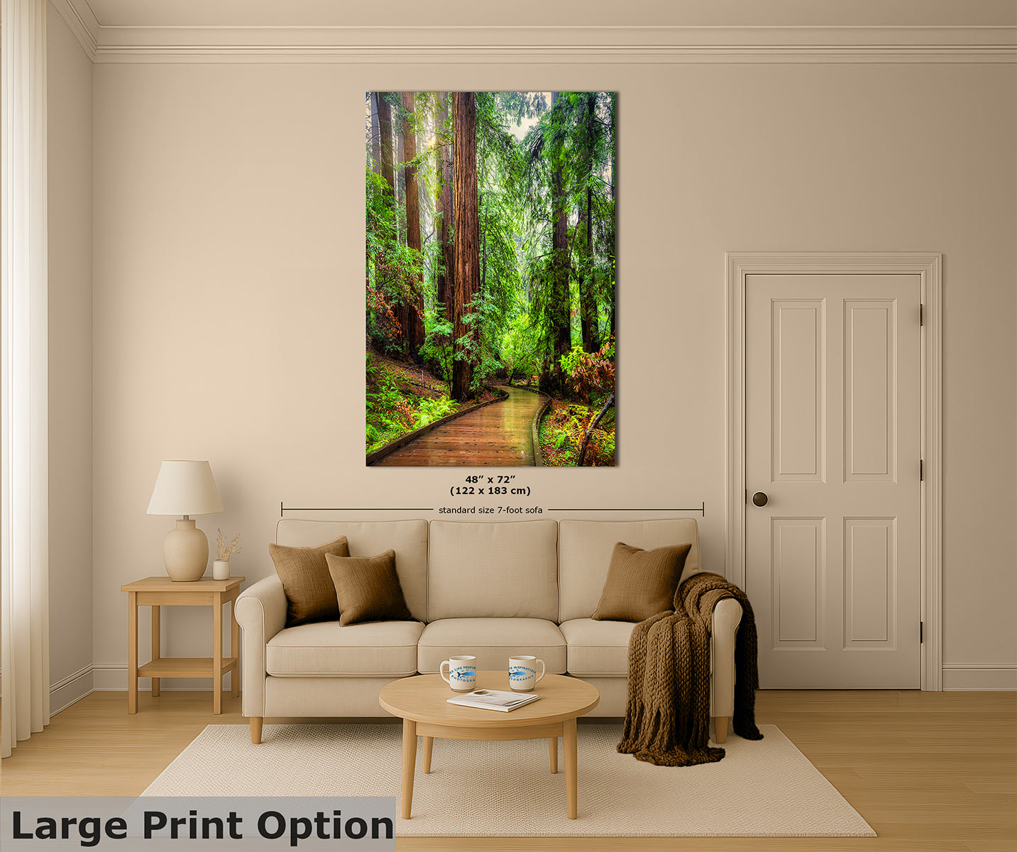 A large vertical wall art print showing a sunlit Redwood forest path with tall trees, displayed above a beige sofa in a styled living room. The print includes size text reading 48 x 72 inches (122 x 183 cm) and a small 'standard size 7-foot wall art' note.