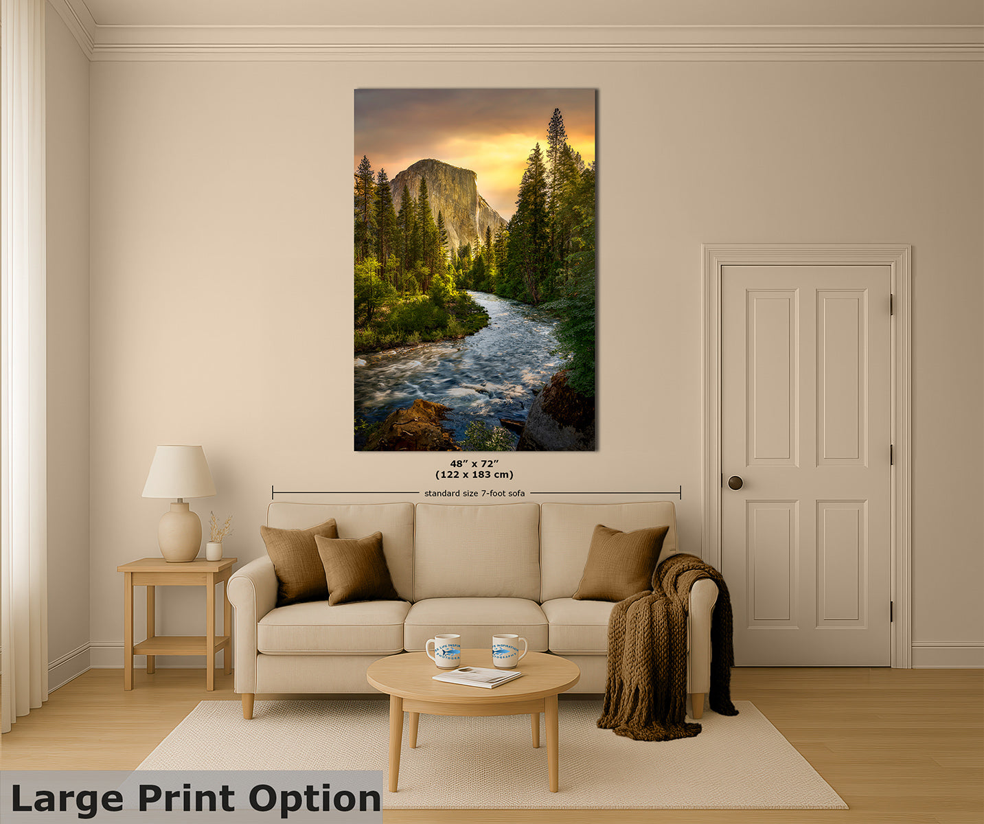 A large vertical wall art print showing a Yosemite mountain scene with El Capitan mountain and a golden sunset, displayed above a beige sofa in a styled living room. The print includes size text reading 48" x 72" (122 x 183 cm) and a small 'standard size 7-foot wall' note.