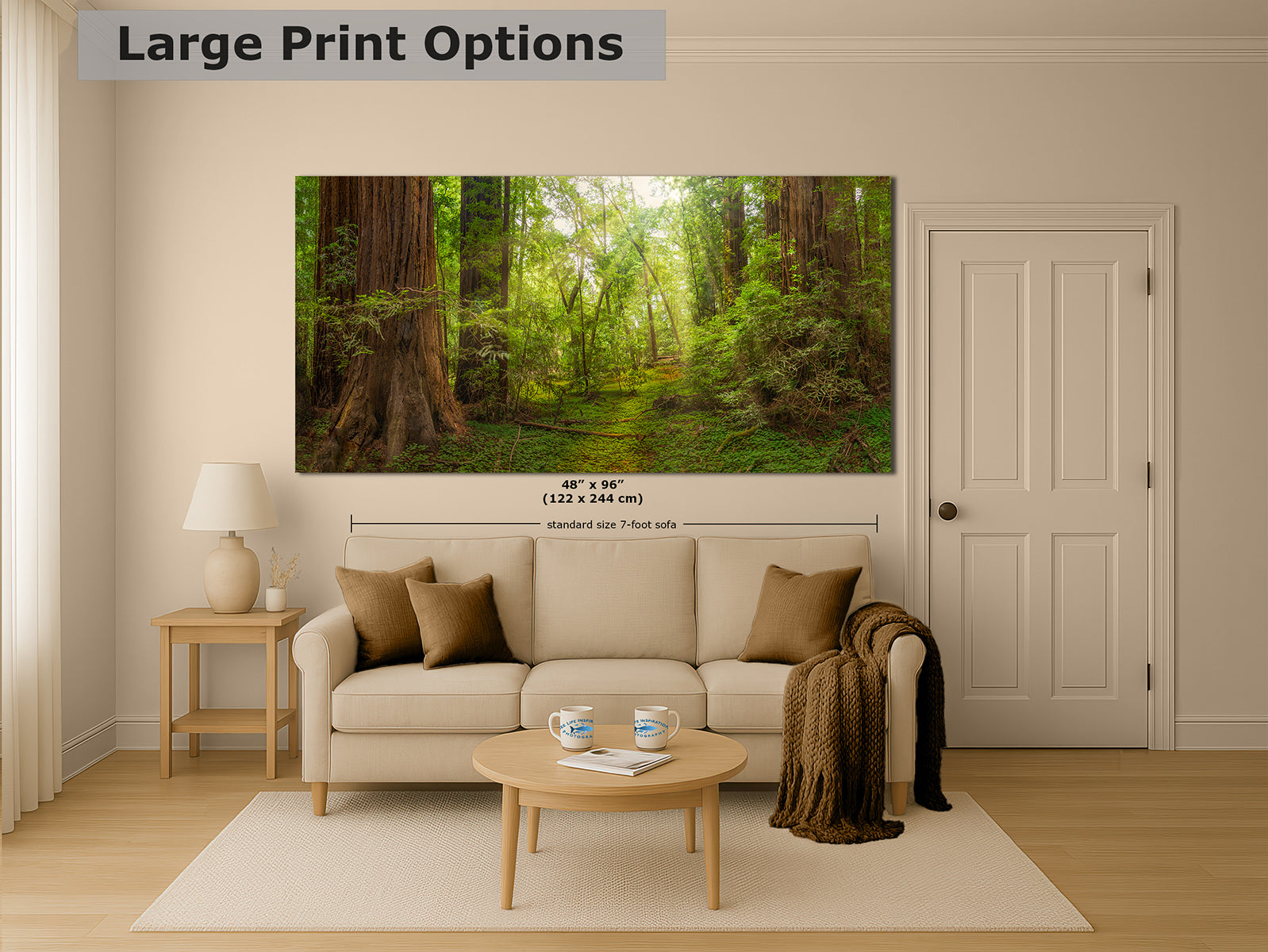 A large wall art print showing a lush green Redwood forest path with tall trees, displayed above a beige sofa in a styled living room. The image includes a text overlay reading 'Large Print Options' and size measurement markings on the print.