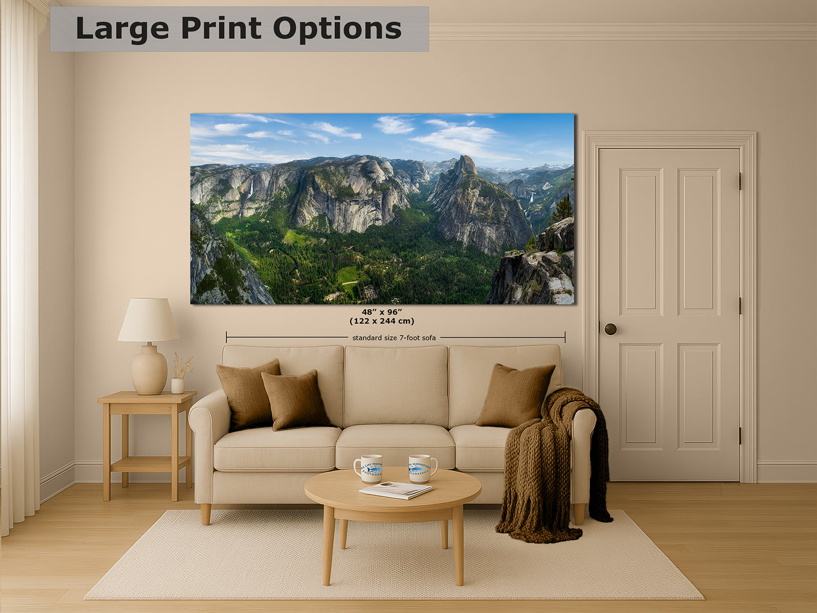 A large wall art print showing Yosemite Valley and Half Dome from Glacier Point, a mountain landscape, is displayed above a beige sofa in a styled living room. The image includes text reading 'Large Print Options' and dimension callouts for the print size.