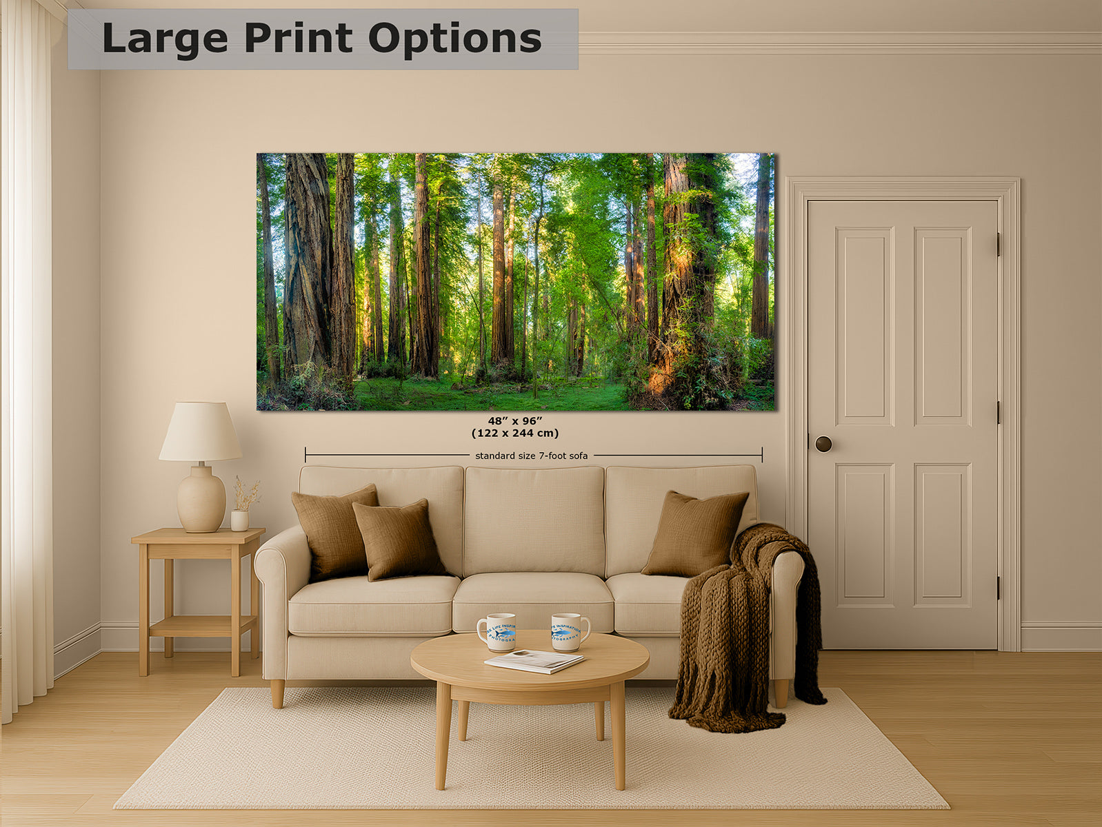 A large wall art print showing a sunlit California Redwood forest with tall trees, displayed above a beige sofa in a styled living room. The image includes the text 'Large Print Options' and a small size measurement overlay.