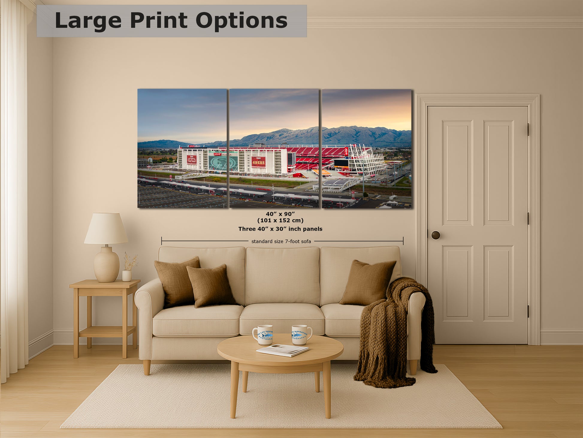 A living room with a large, colorful, three-panel print of a stadium or sports arena displayed on the wall.