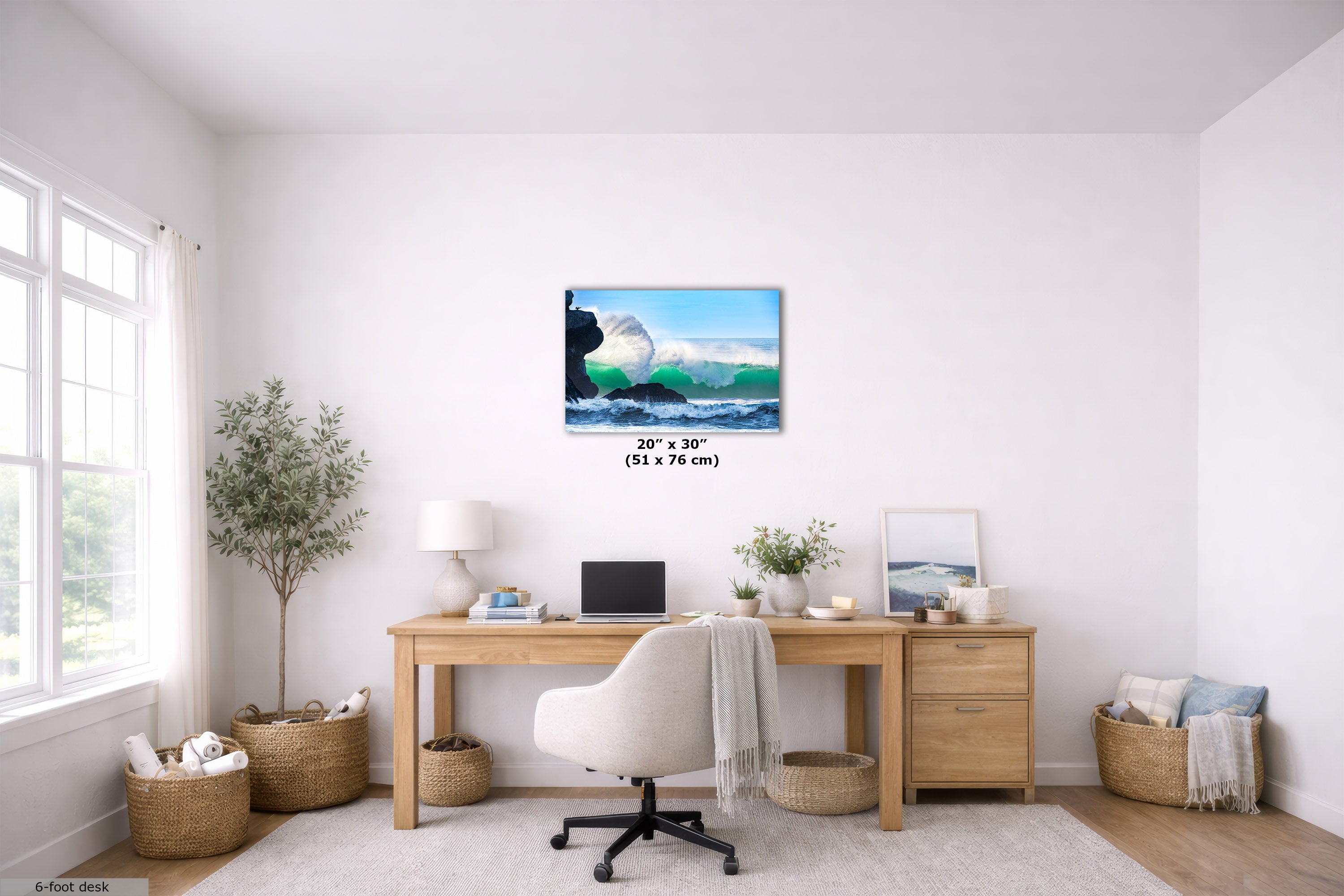 A wall art print depicting a blue ocean wave, displayed in a bright, modern home office setting above a wooden desk. The print has a dimension label overlay reading '20" x 30" (51 x 76 cm)'.