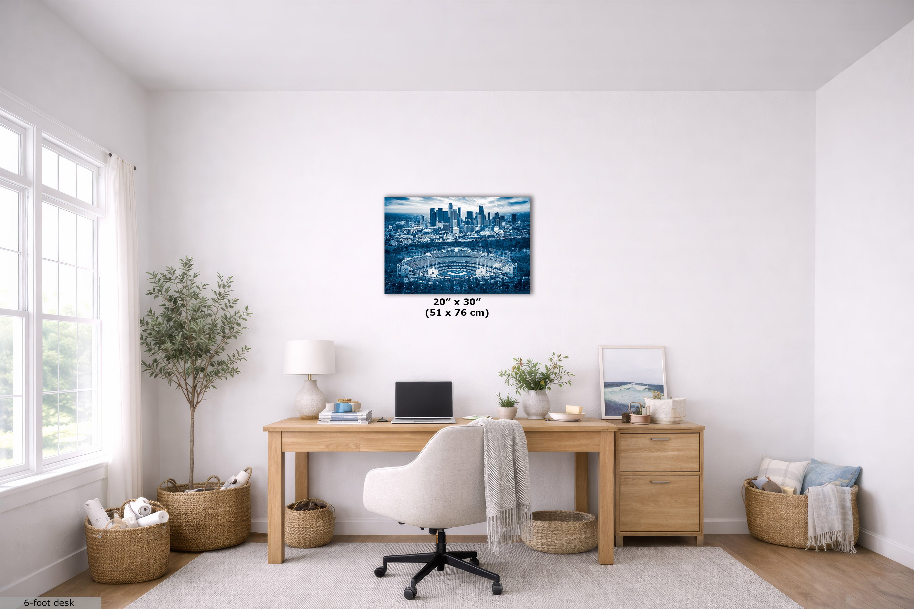 A blue-toned city skyline wall art print is displayed above a wooden desk in a bright, modern home office. The print is shown with size text indicating 20" x 30" (51 x 76 cm).