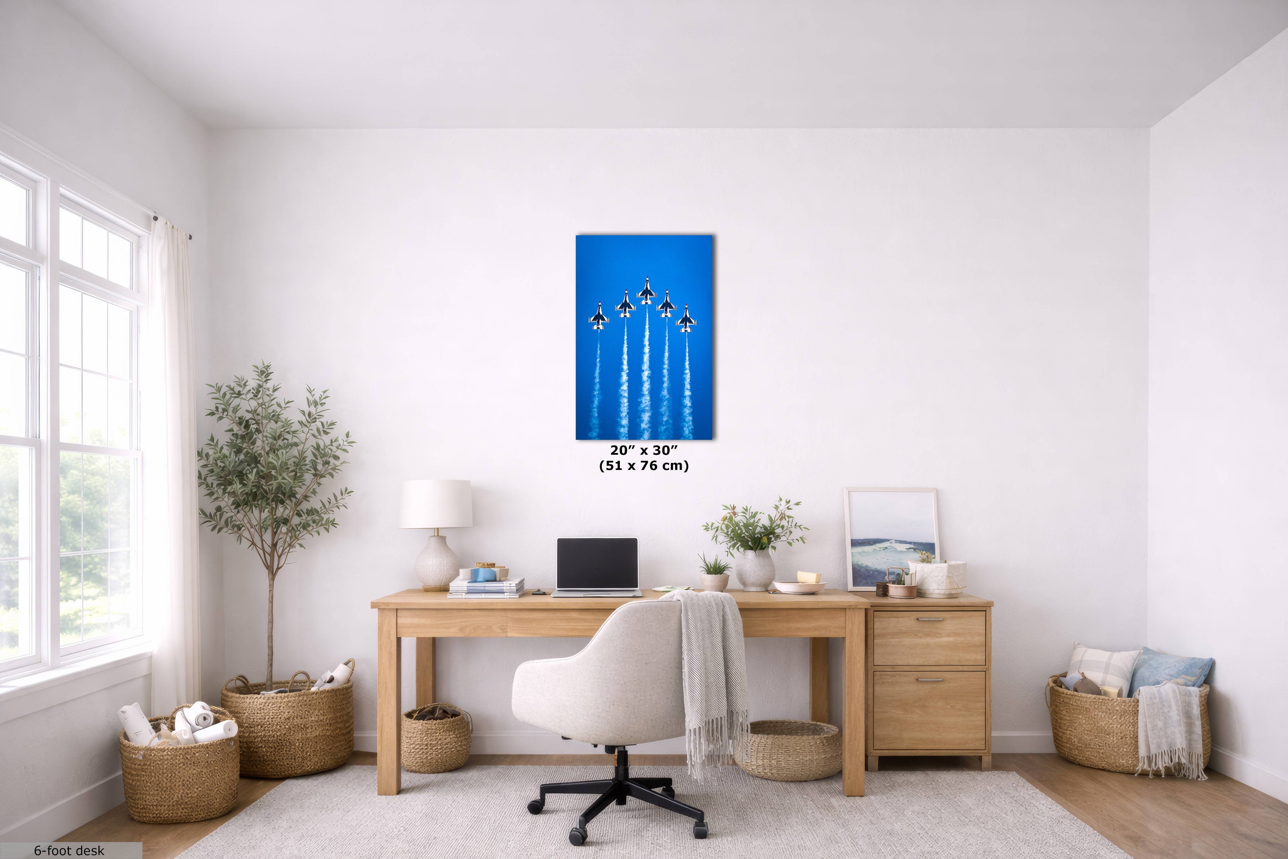 A vertical canvas wall art print featuring the USAF F-16 Fighting Falcon fighter jets against a bright blue sky, displayed in a modern, bright home office setting above a wooden desk.