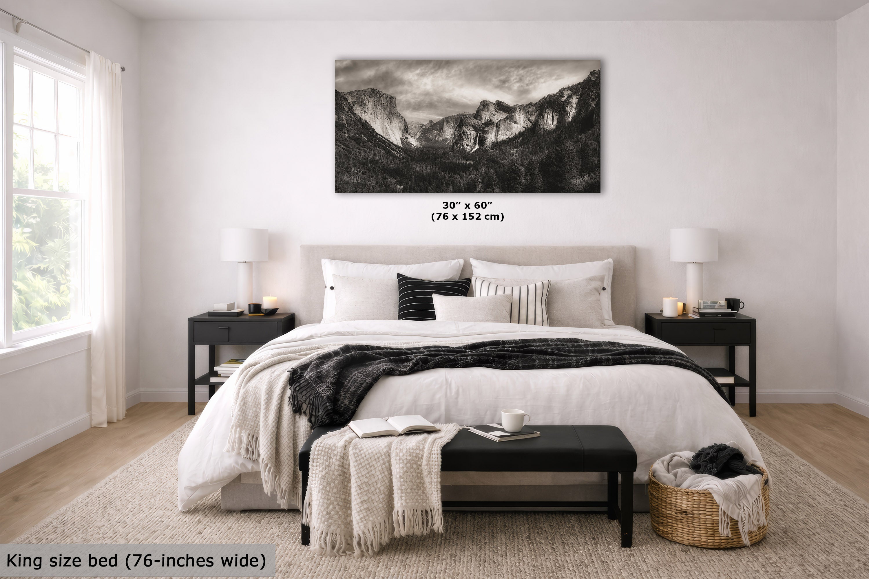 A black and white landscape canvas print of a mountain range is displayed on a light gray wall above a neatly made bed in a modern, minimalist bedroom. The text overlay indicates the size is 30" x 60" (76 x 152 cm).
