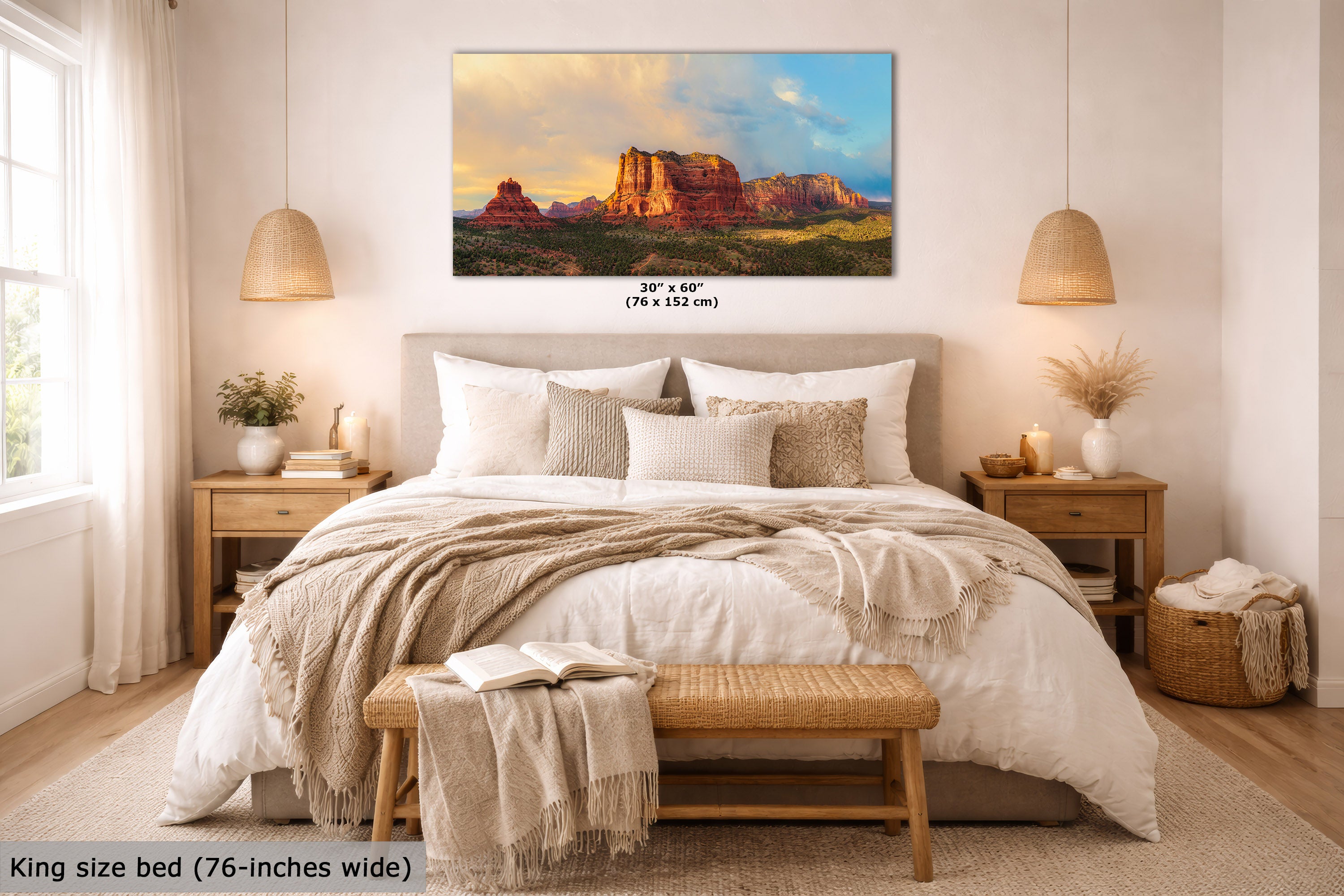 A framed wall art print showing a desert landscape with red rock formations under a blue sky, displayed above a neatly made bed in a bright, modern bedroom. The print includes size text reading 30" x 45" (76 x 152 cm), and a small caption at the bottom left says king size bed (76-inches wide).
