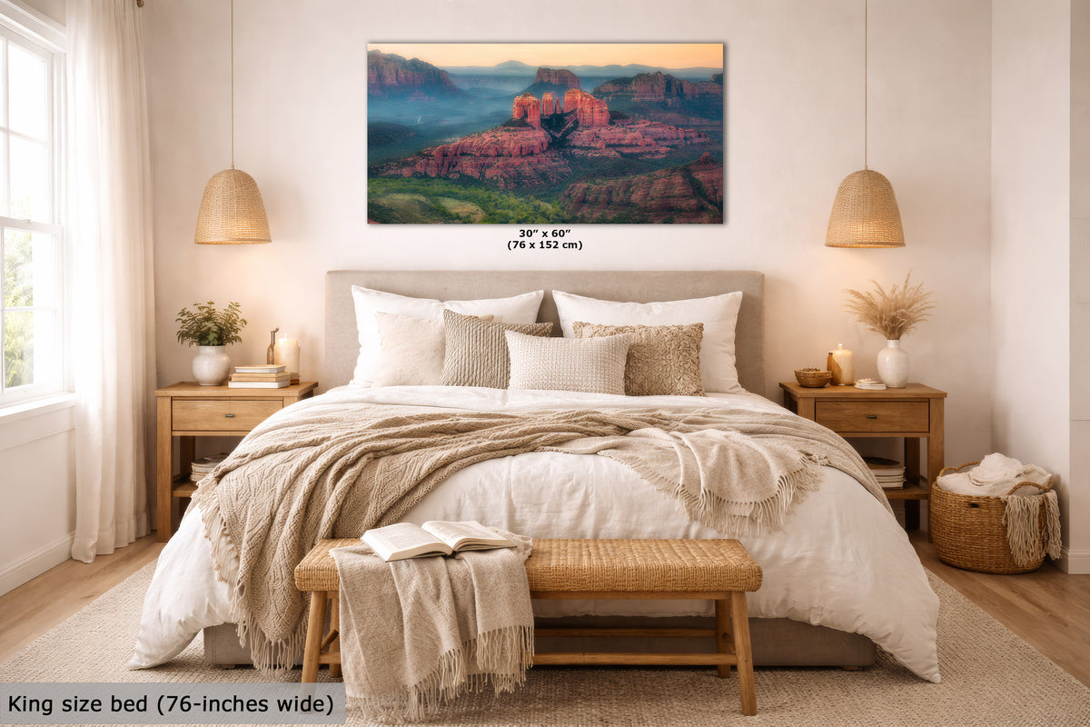 A landscape wall art print showing red rock desert formations at sunrise, displayed above a neatly made bed in a bright, modern bedroom. The print includes size text reading 30 x 60 inches (76 x 152 cm), and the room scene includes a king size bed and text noting 76-inches wide.