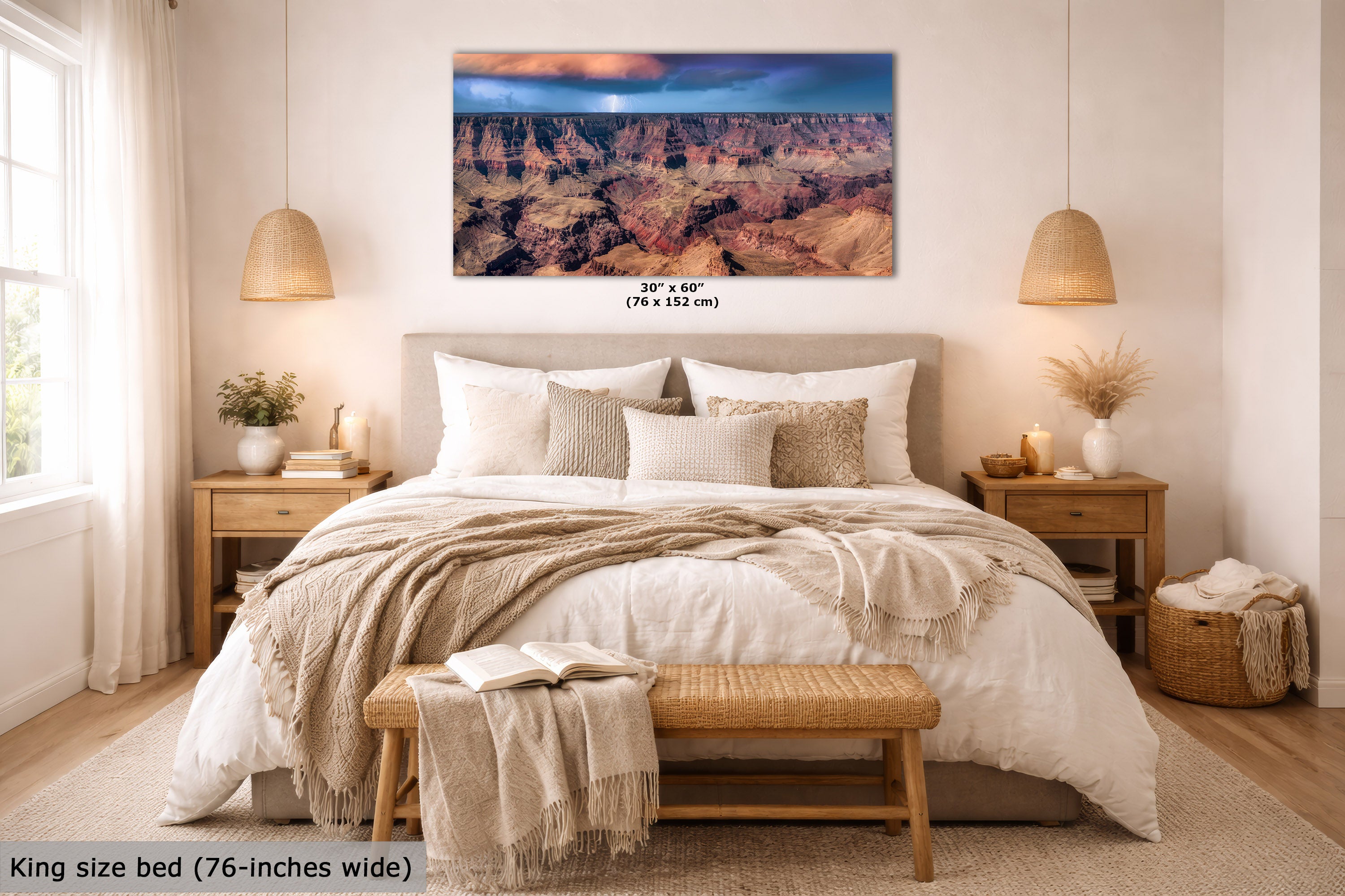 A wall art print showing a canyon landscape is displayed above a neatly made bed in a bright, modern bedroom. The print includes size text reading 30 x 60 inches (76 x 152 cm), and the room scene includes a king size bed and text noting 76-inches wide.