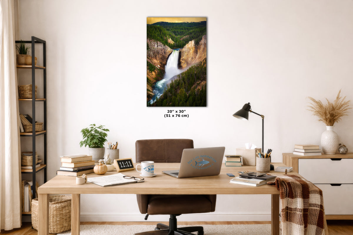 A framed wall art print depicting a scenic waterfall and forest canyon, displayed above a wooden desk in a styled home office setting. The print includes size text reading 20" x 30" (51 x 76 cm) below it.