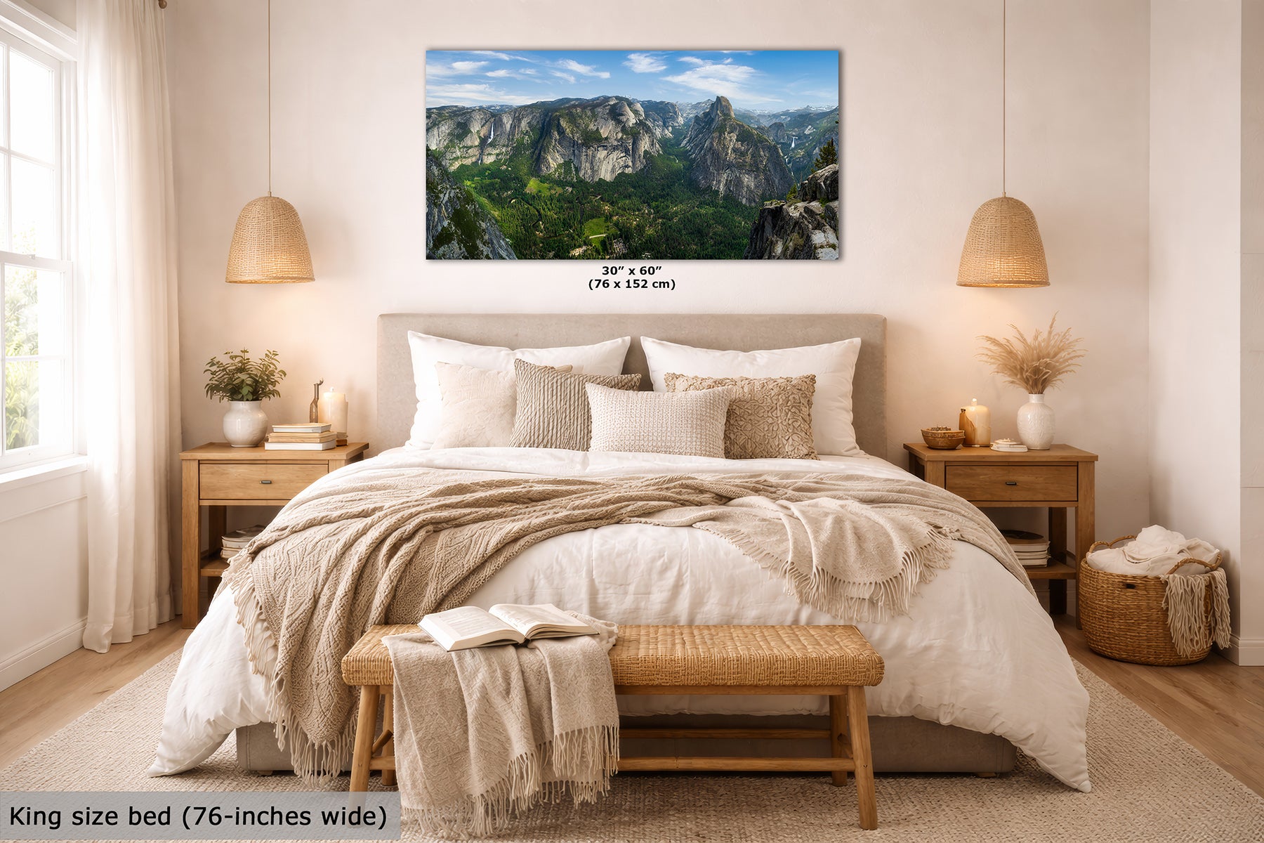 A framed wall art print showing Yosemite Valley and Half Dome from Glacier Point, a mountain landscape with green valleys and blue sky, displayed above a neatly made bed in a bright, modern bedroom. The print includes size text reading 30" x 60" (76 x 152 cm), and a caption at the bottom says King size bed (76-inches wide).