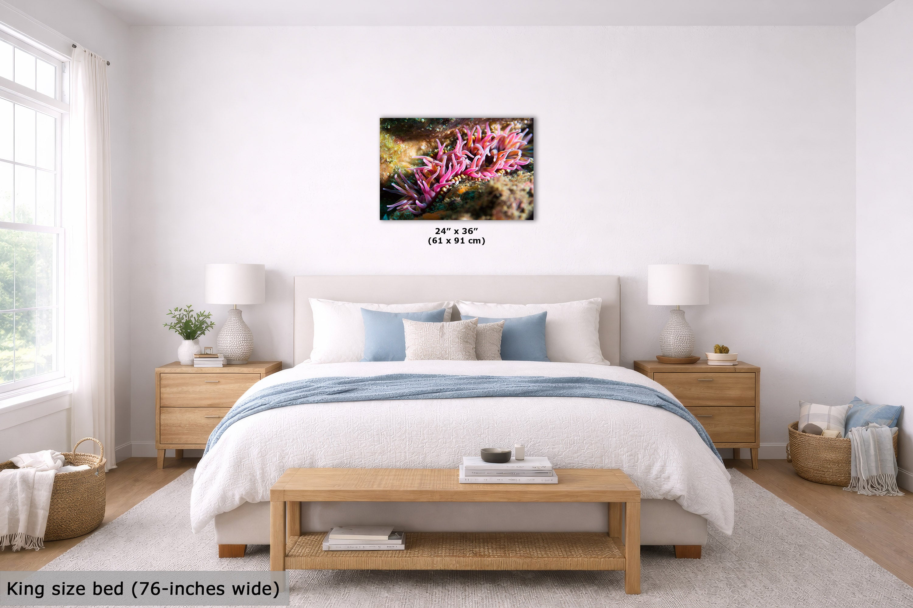 A bedroom scene showing a framed wall art print above a bed. The artwork depicts a colorful underwater coral scene with pink, purple, green, and blue tones.