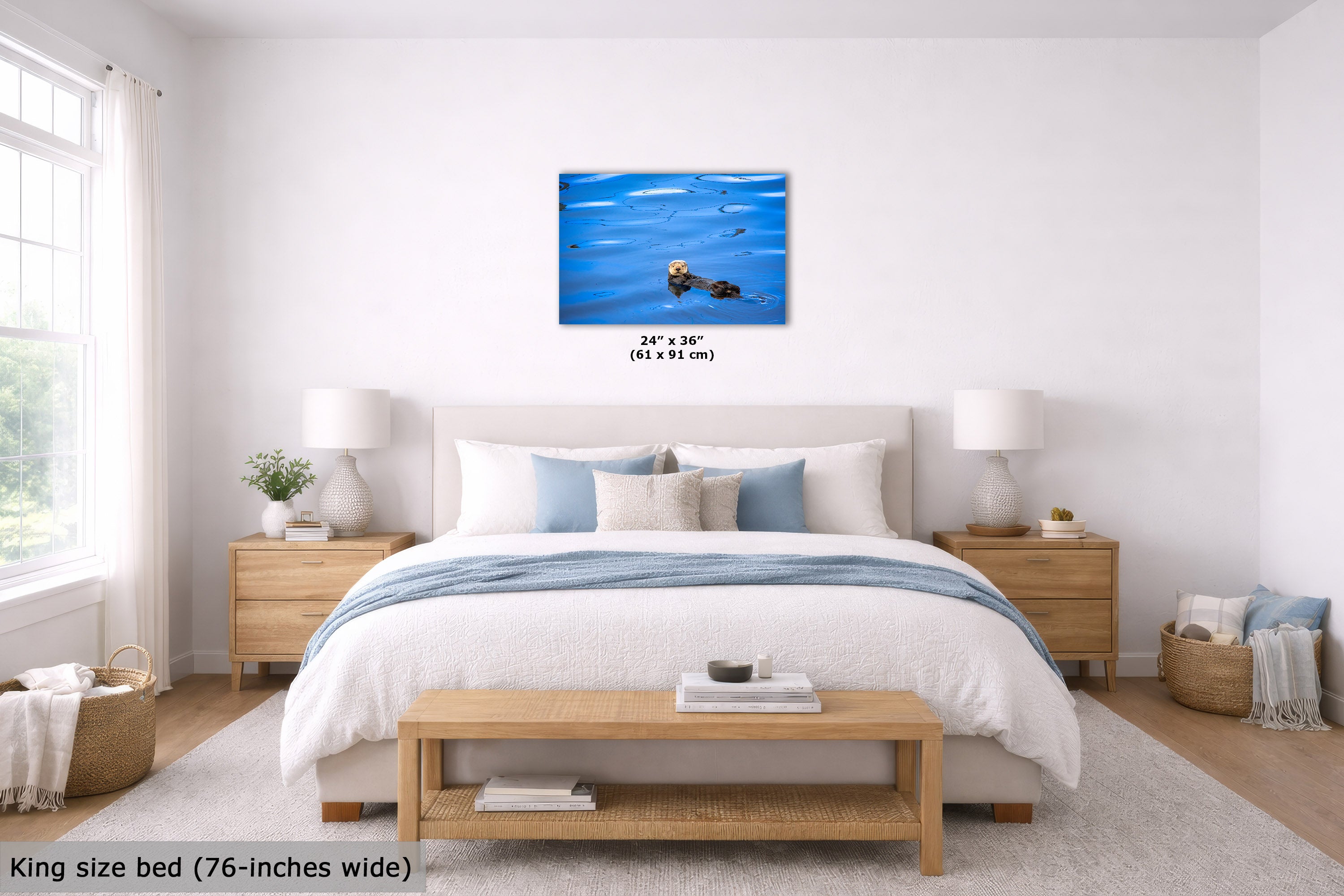 A wall art print showing a blue ocean scene, displayed above a neatly made bed in a bright, modern bedroom. The print includes size text reading 24" x 36" (61 x 91 cm).