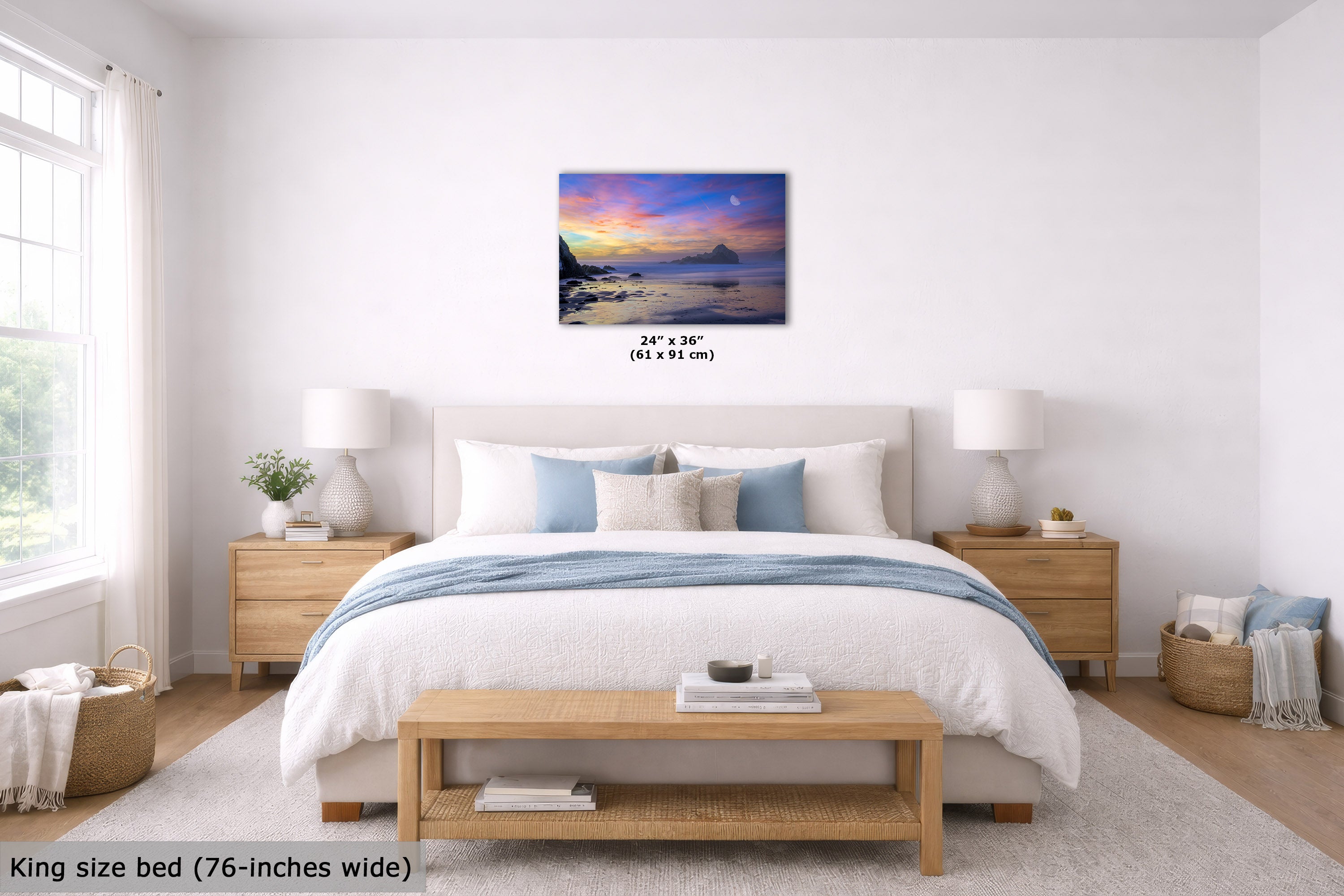 A bedroom scene showing a wall art print above a bed. The print depicts a colorful sunset or sunrise over water with a small boat and mountains.