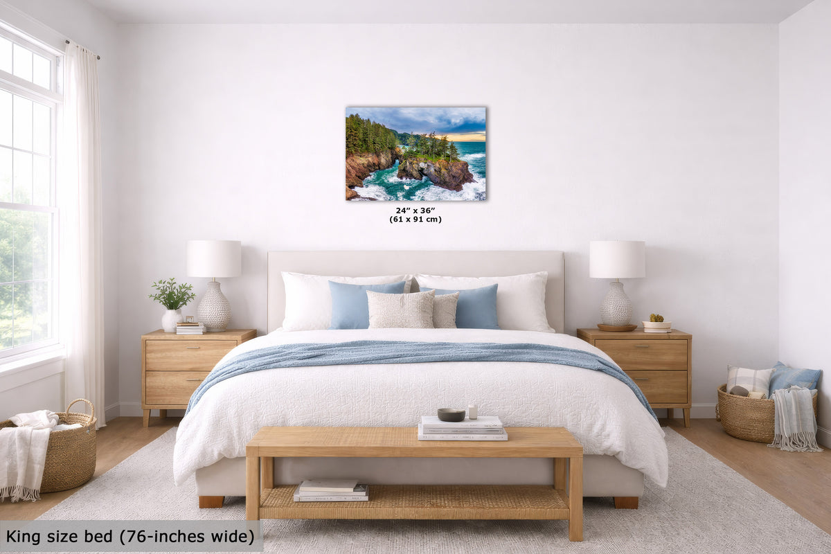 A wall art print showing a coastal landscape with green trees, blue water, and a bright sky, displayed above a neatly made bed in a bright, modern bedroom. The print includes size text reading 24 x 36 inches (61 x 91 cm) and the image is labeled 'King size bed (76-inches wide)' in the lower left corner.