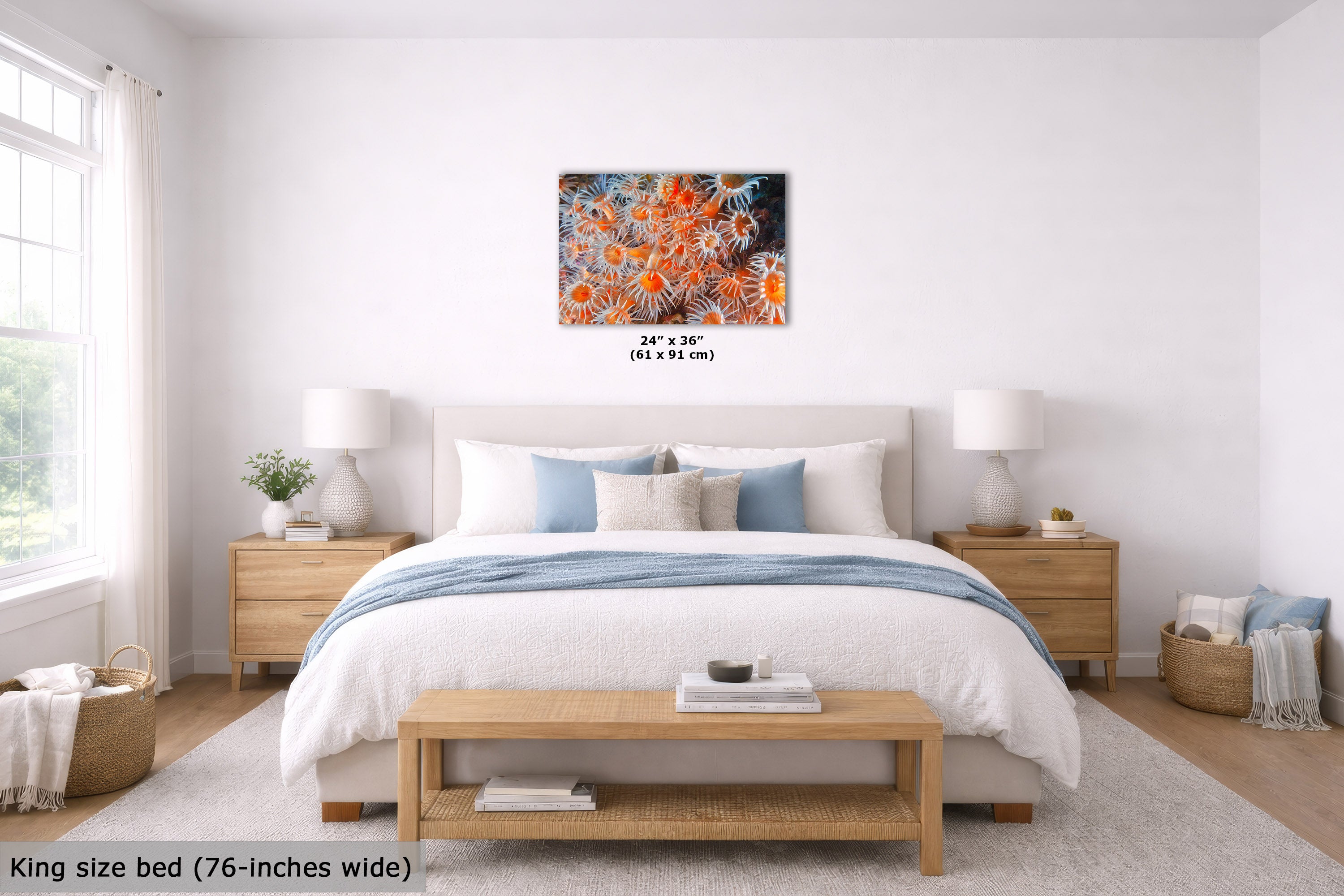 A bedroom scene showing an abstract wall art print above a neatly made bed. The artwork has a black background with vivid orange, red, and yellow floral or coral-like patterns.