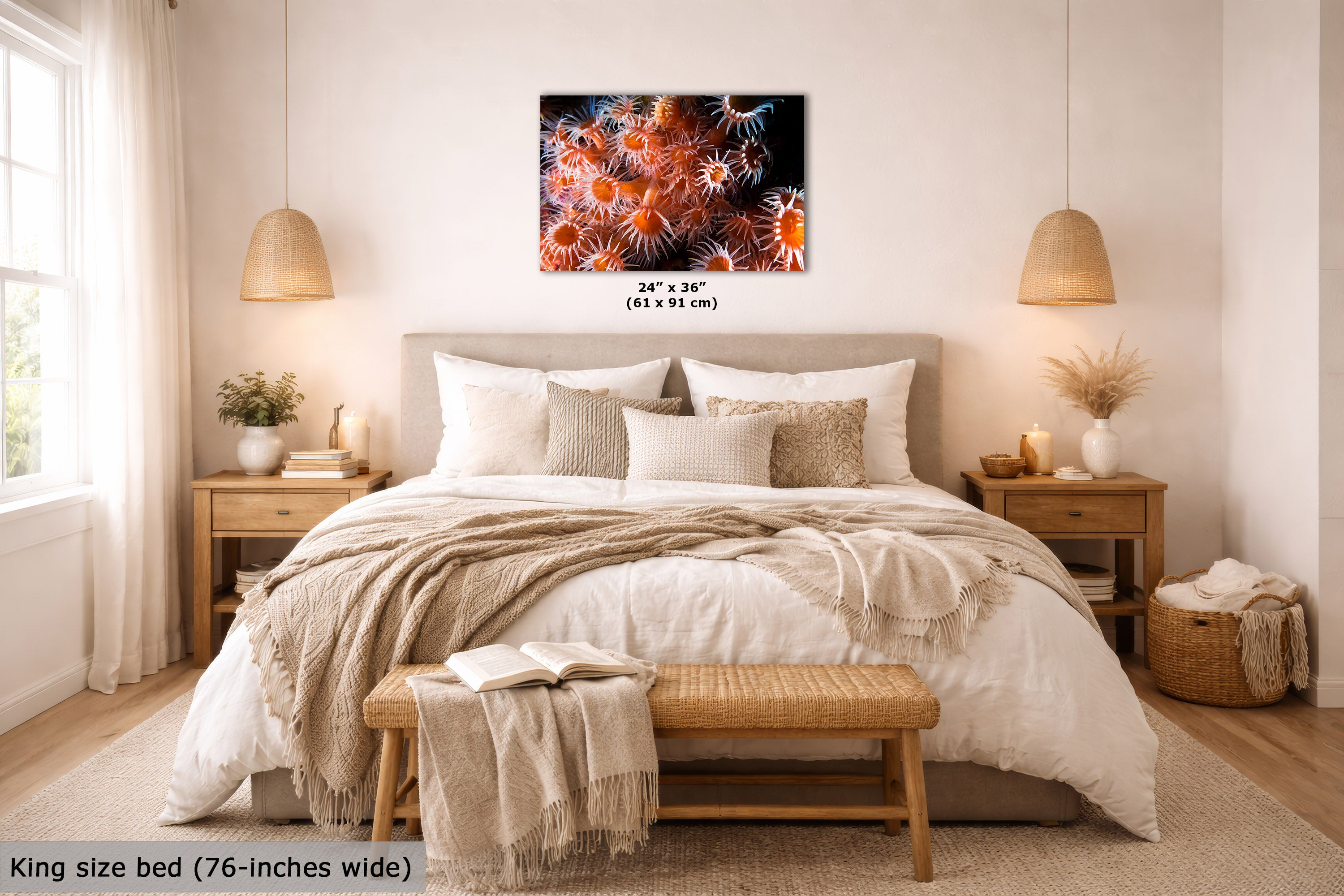 A wall art print showing a close-up of orange and white sea anemones on a dark background, displayed above a neatly made bed in a bright, modern bedroom. Text on the image indicates the print size as 24 x 36 inches (61 x 91 cm) and notes the bed is king size (76 inches wide).