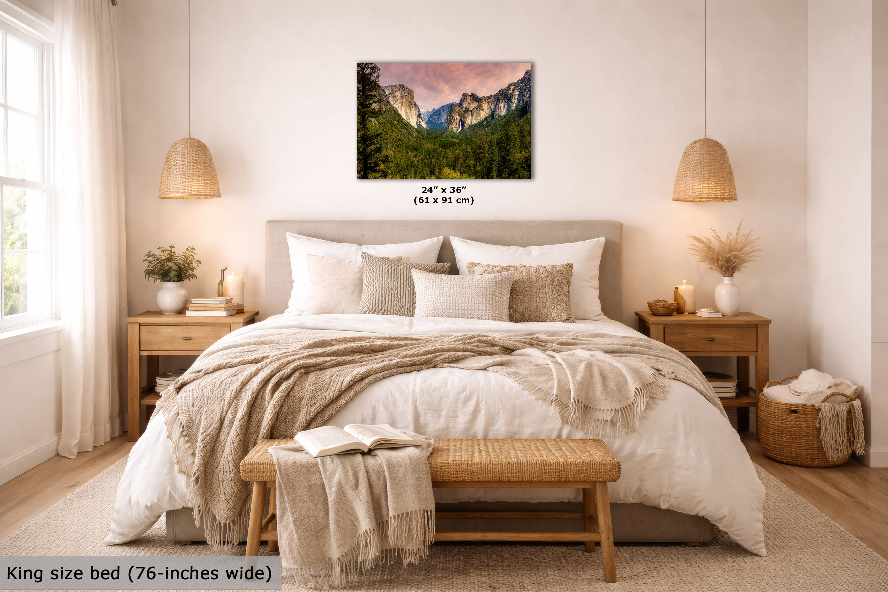 A wall art print showing a mountain landscape with green forest and a pink sky, displayed above a neatly made bed in a bright, modern bedroom. The print includes size text reading 24 x 36 inches (61 x 91 cm), and the room scene also includes a bed, nightstands, lamps, and a bench.