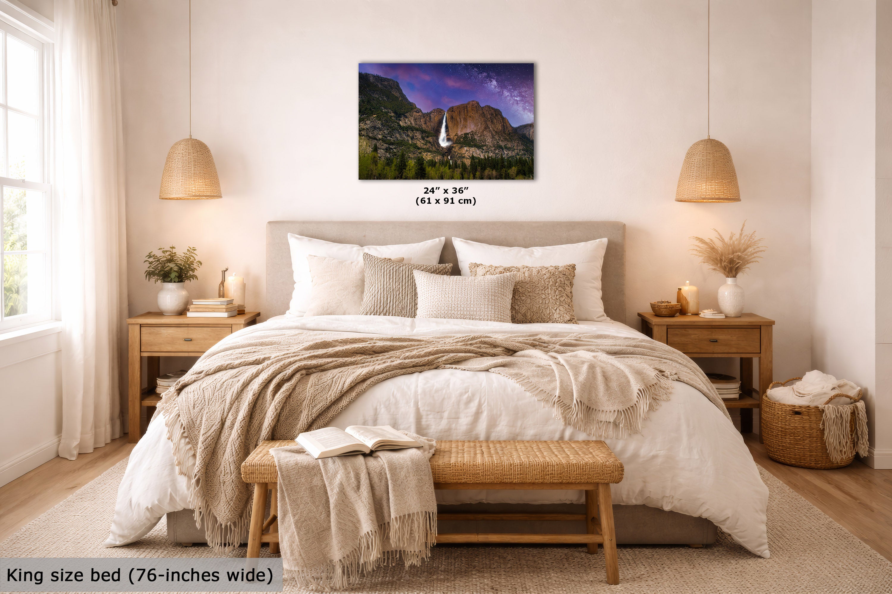 A wall art print showing a mountain landscape with a sailboat and purple sky, displayed above a neatly made bed in a bright, modern bedroom. The print includes size text reading 24 x 36" (61 x 91 cm).