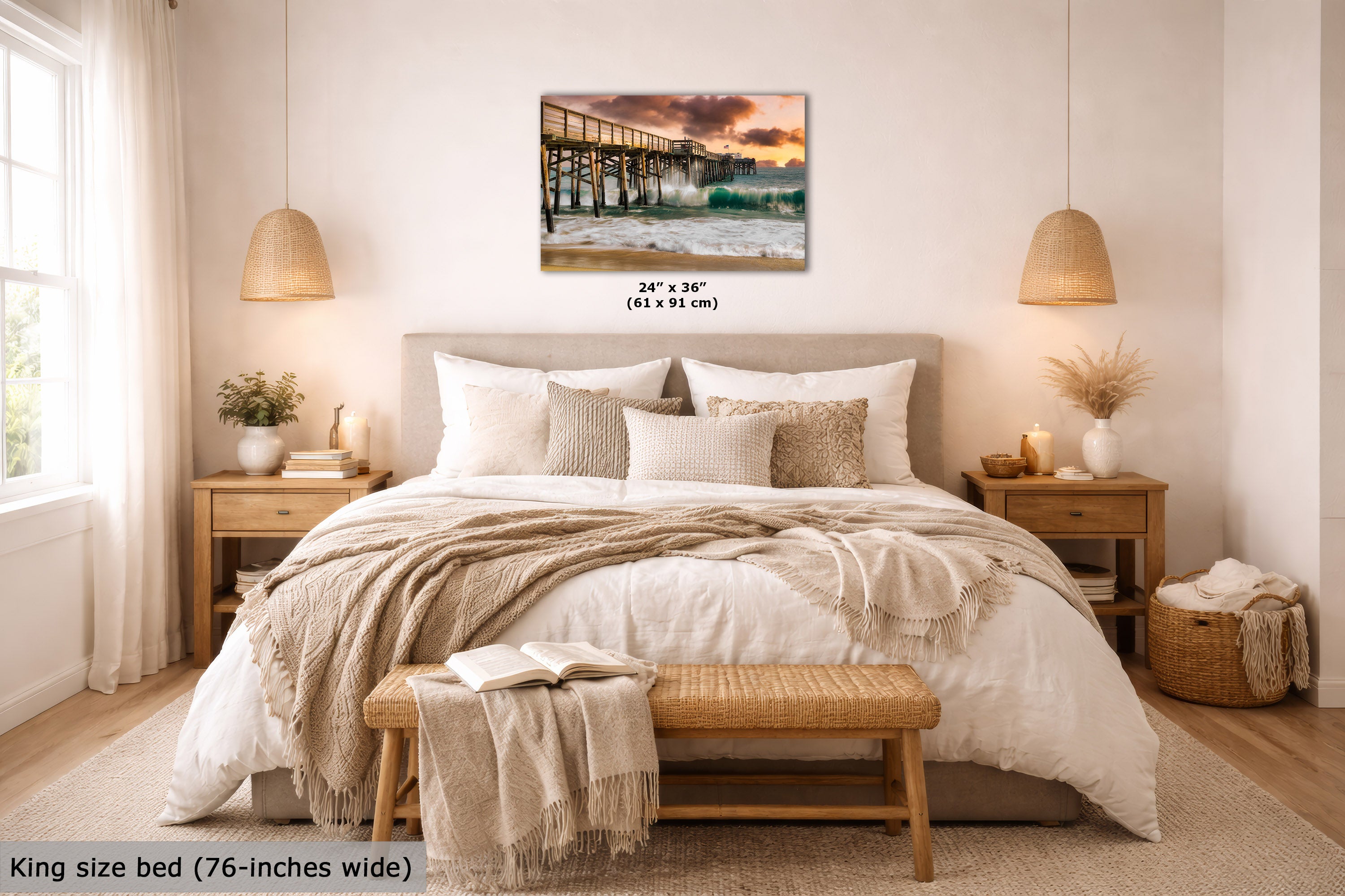 A wall art print showing a pier at sunset hangs above a neatly made bed in a bright, modern bedroom. The print includes size text reading 24 x 36 inches (61 x 91 cm), and the room scene also includes a text label at bottom left stating king size bed (76-inches wide).
