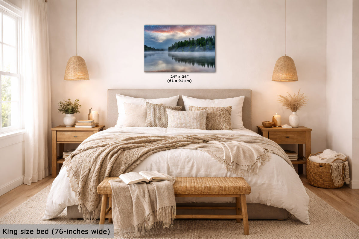 A wall art print showing a misty forest lake at dusk, displayed above a neatly made bed in a bright, modern bedroom. The print includes size text reading 24" x 36" (61 x 91 cm), and the room scene also includes a bed, nightstands, lamps, and a bench.