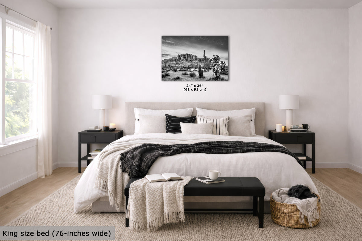 A black and white cityscape canvas print displayed on a light gray wall above a neatly made bed in a modern, bright bedroom. The text 'King size bed (76-inches wide)' is visible in the bottom left corner.