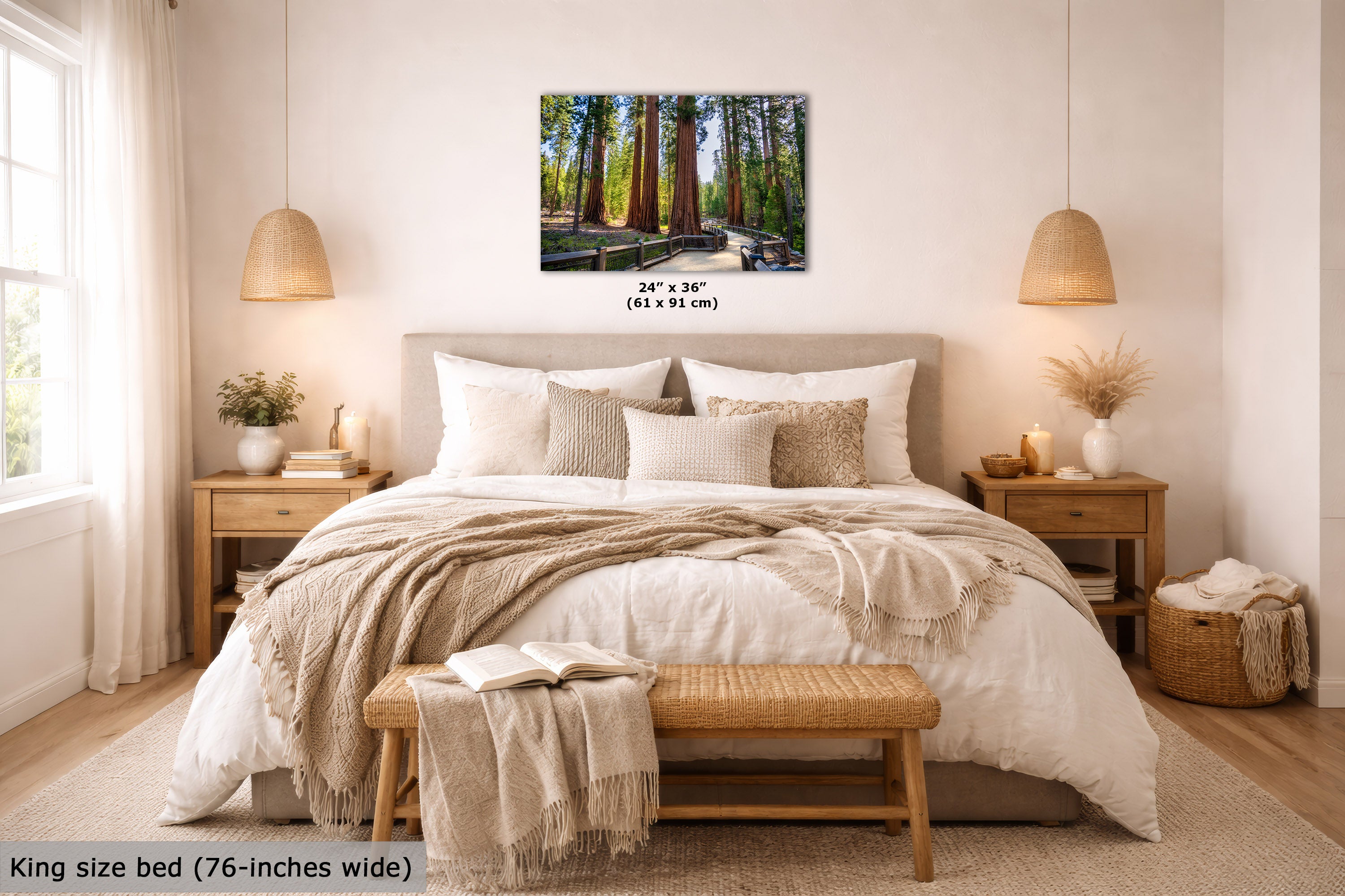 A framed forest wall art print hangs above a neatly made bed in a warm, modern bedroom. The print shows tall redwood trees and a wooden path, with size text below it.