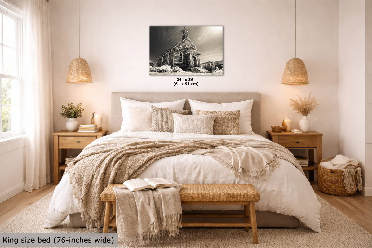 A black-and-white wall art print showing a church building, displayed above a neatly made bed in a bright, neutral-toned bedroom. The print includes size text reading 24 x 36 inches (61 x 91 cm), and the room scene also includes a text overlay noting a king size bed is 76 inches wide.