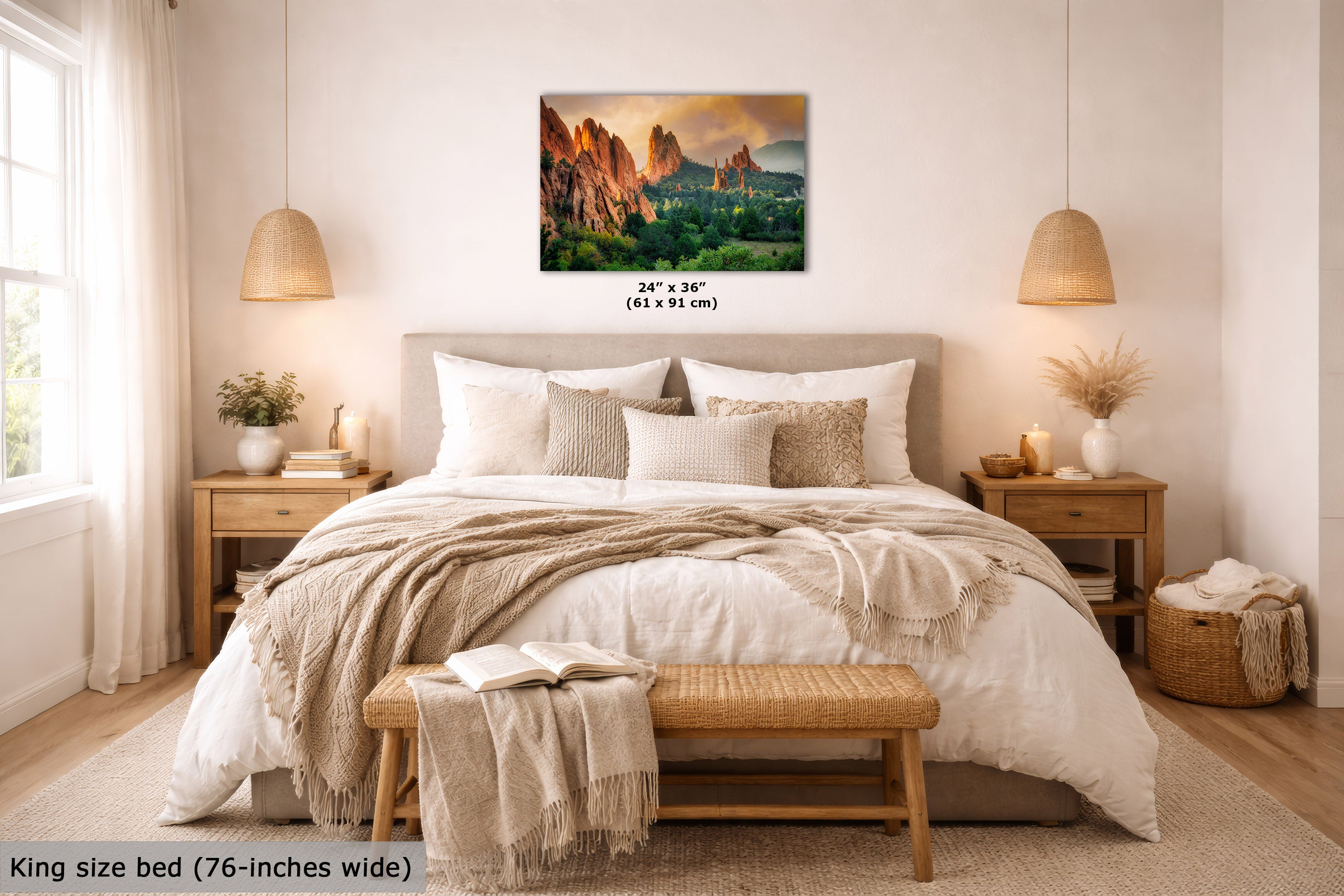 A landscape wall art print showing a desert canyon scene with warm orange rock formations and green water, displayed above a neatly made bed in a bright, modern bedroom. The print includes size text reading 24" x 36" (61 x 91 cm).