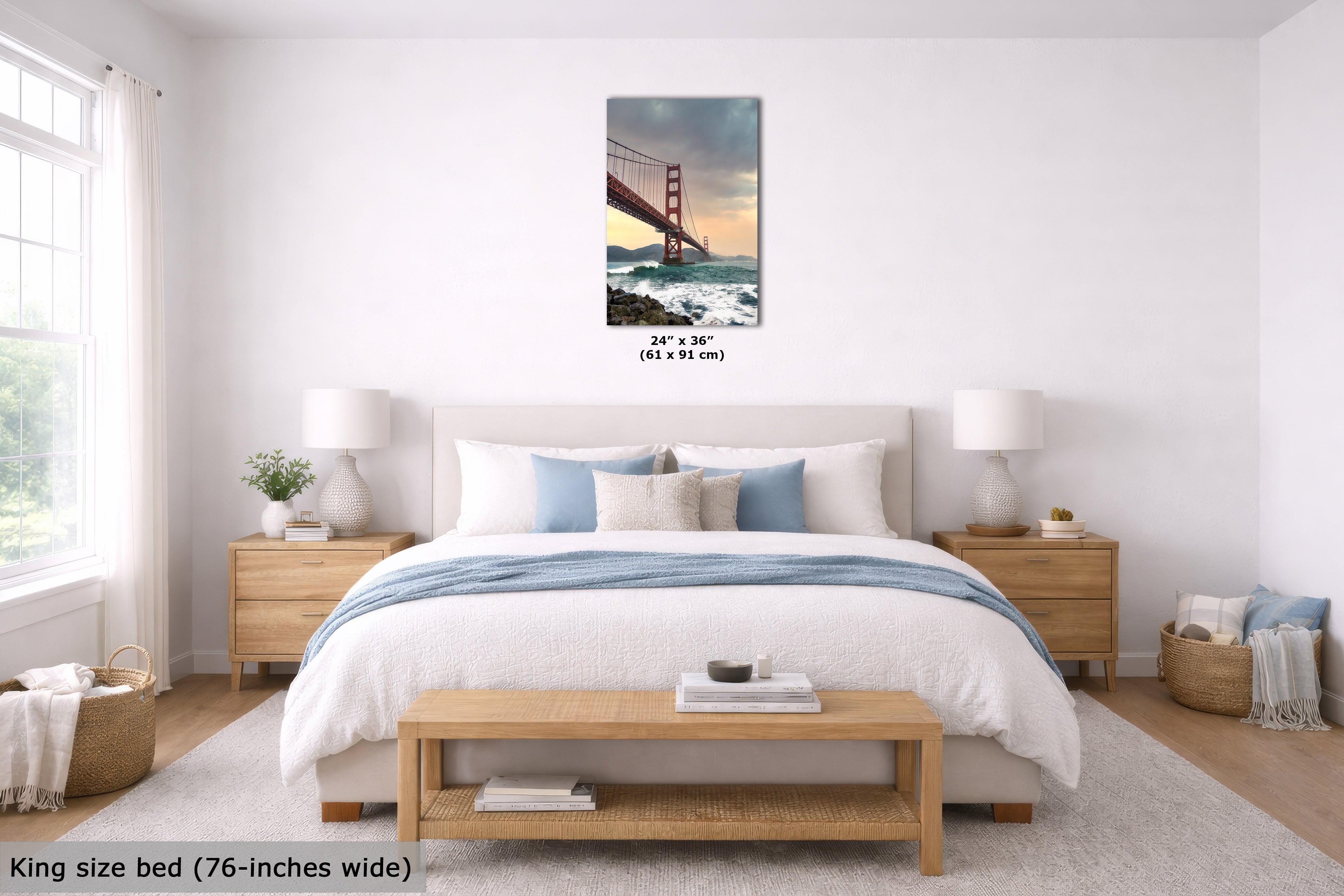 A bedroom scene showing a framed wall art print of the Golden Gate Bridge above a neatly made bed. The print includes size text reading 24 x 36 inches (61 x 91 cm).