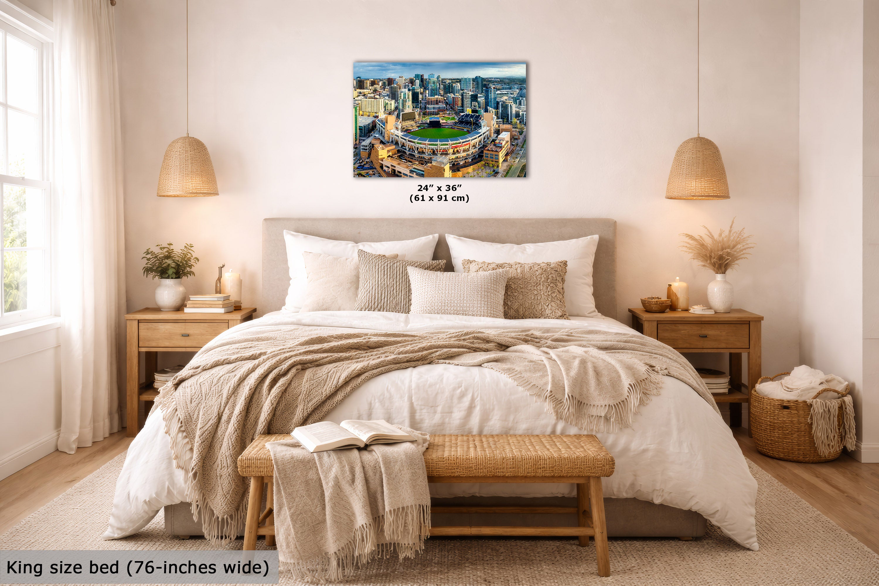 A cityscape wall art print hangs above a neatly made bed in a bright, modern bedroom. The artwork shows a blue-toned urban skyline with a green field in the center.