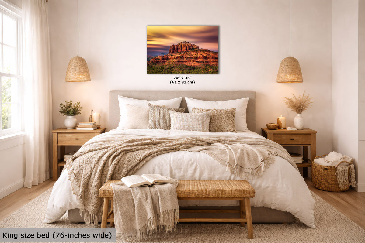 A wall art print showing a desert rock formation at sunset hangs above a neatly made bed in a bright, modern bedroom. The print includes size text reading 24 x 36 inches, and the room scene also includes a text note saying king size bed (76-inches wide) at the bottom left.