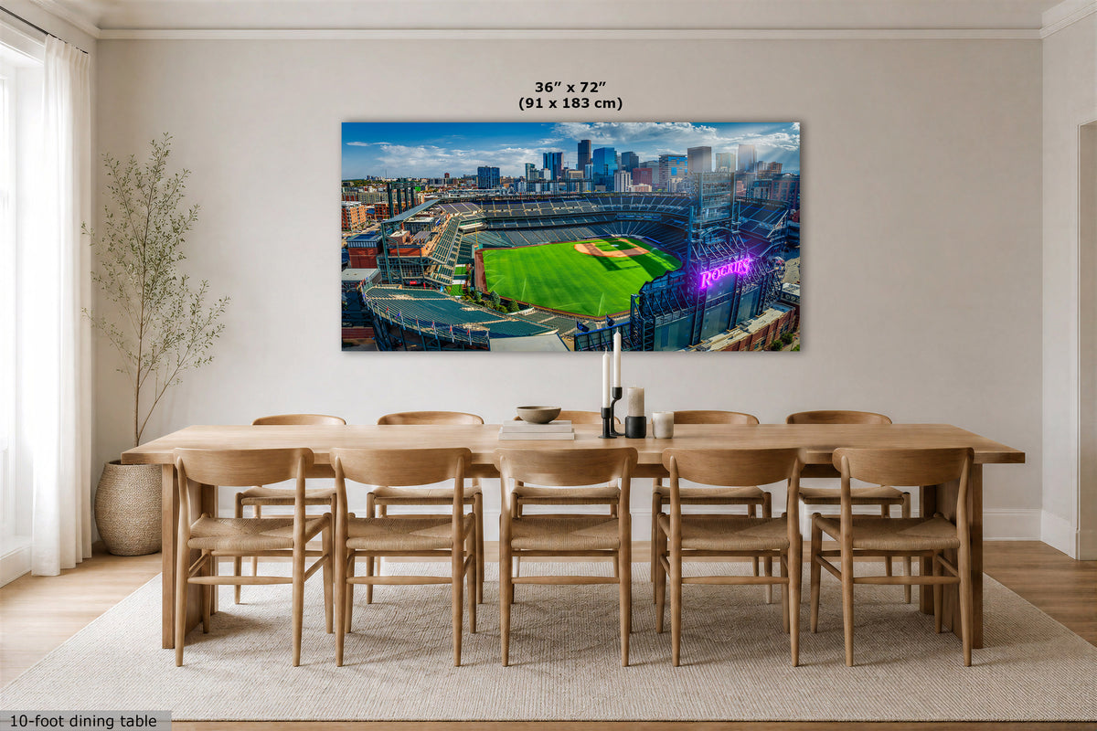 A large rectangular wall art print showing a baseball stadium cityscape hangs above a wooden dining table and chairs in a bright modern room. The print includes a size annotation reading 36 x 72 in (91 x 183 cm).