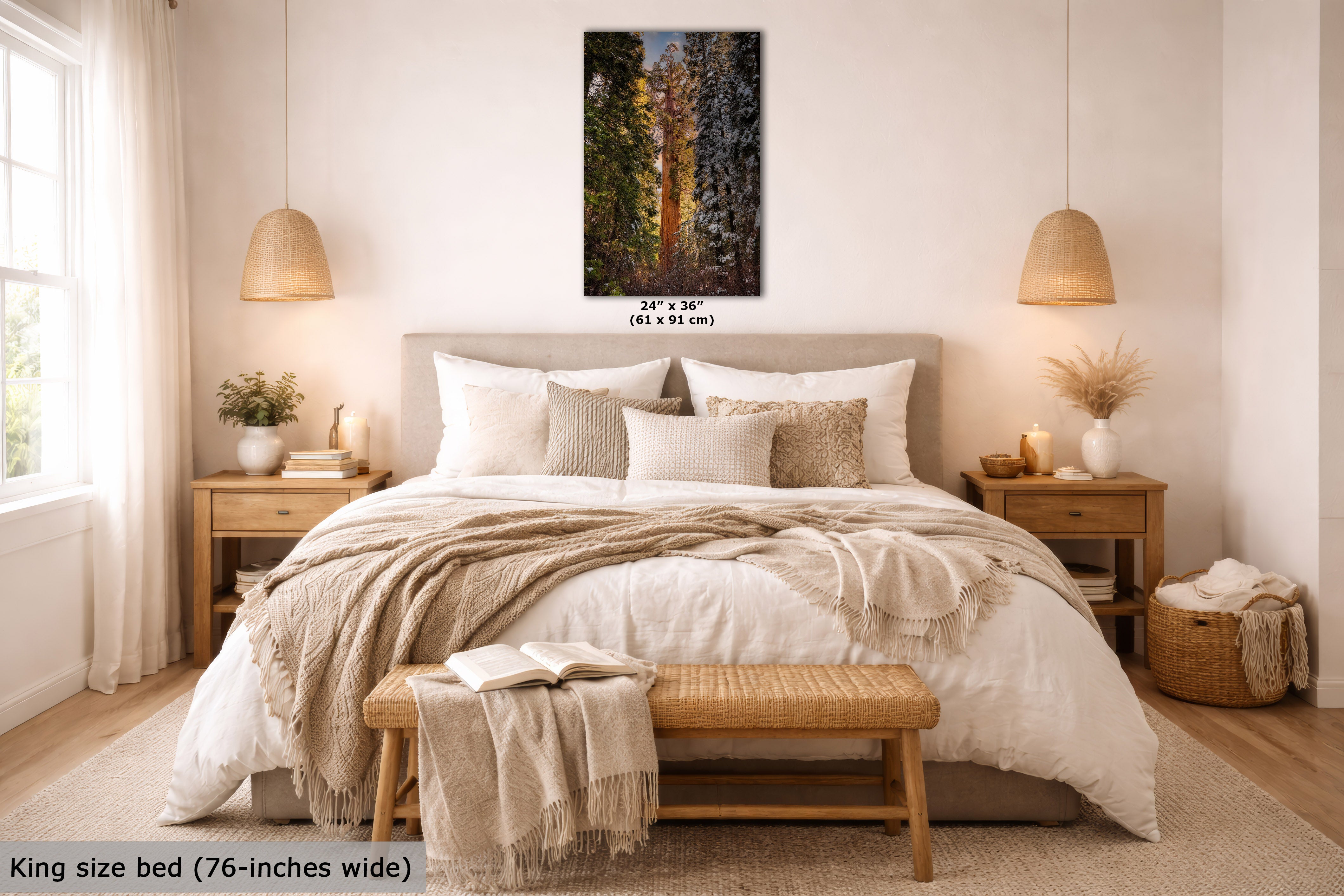 A framed vertical forest landscape wall art print is displayed above a neatly made bed in a bright, modern bedroom. The print shows tall trees with golden sunlight filtering through the forest.